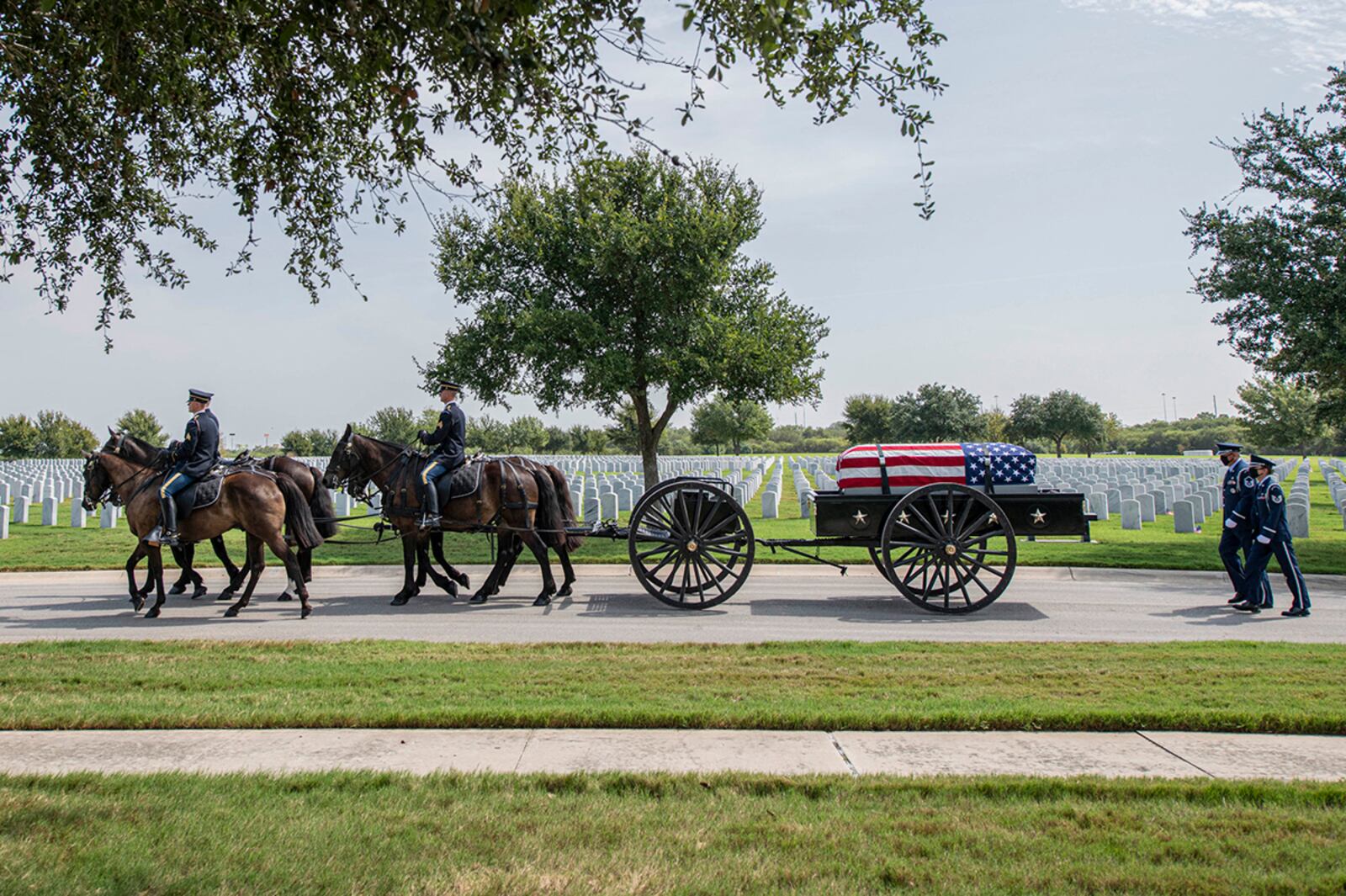 Soldiers with the Fort Sam Houston Caisson Section carry the flag-draped remains of Col. Richard E. Cole during his interment ceremony Sept. 7 at the Fort Sam Houston National Cemetery, Texas. Cole remained a familiar face within the Air Force after his retirement, touring Air Force schoolhouses and installations to help promote the spirit of service among Airmen. U.S. AIR FORCE PHOTO/TRISTIN ENGLISH