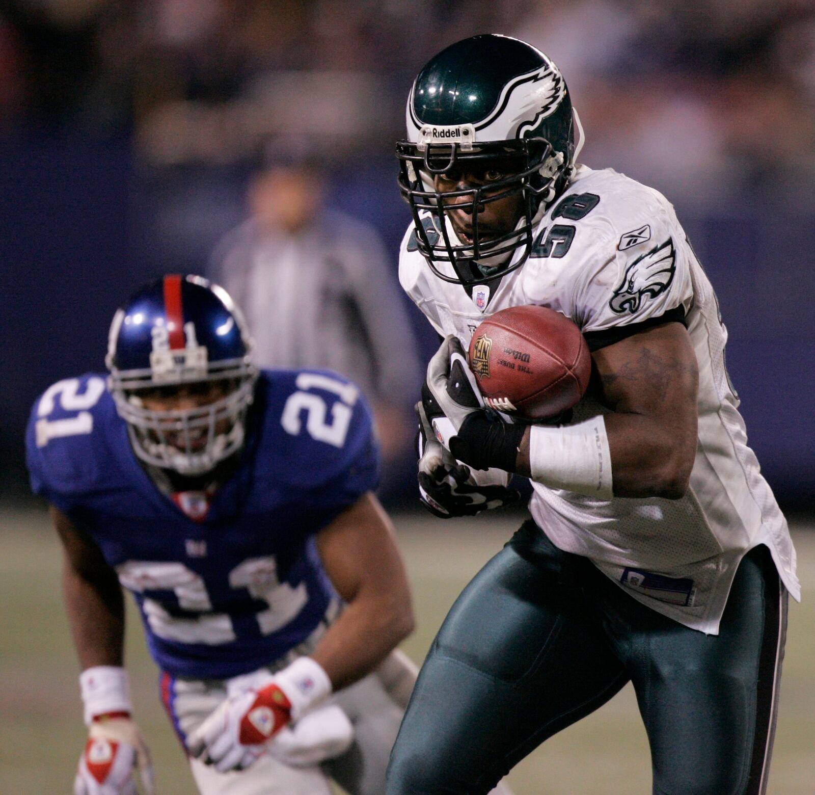 Philadelphia Eagles' Trent Cole, right, intercepts a pass by New York Giants' Eli Manning in front of Tiki Barber in the fourth quarter during NFL football action Sunday, Dec. 17, 2006 in East Rutherford, N.J. Cole ran the interception back for a touchdown sealing the Eagles' 36-22 win. (AP Photo/Julie Jacobson)