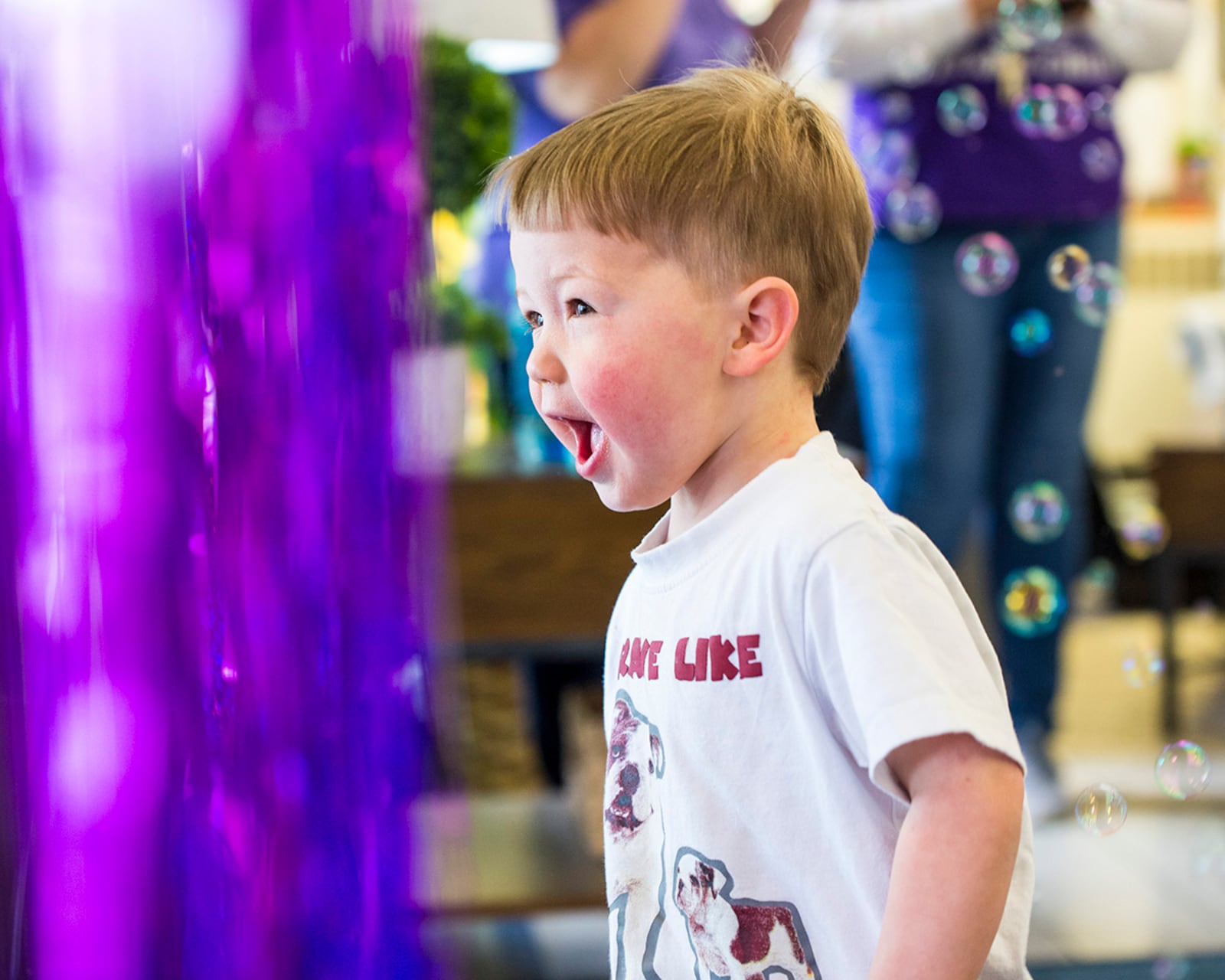 A child plays in bubbles as he leaves the Wright-Field South Child Development Center on April 29. U.S. AIR FORCE PHOTO/JAIMA FOGG