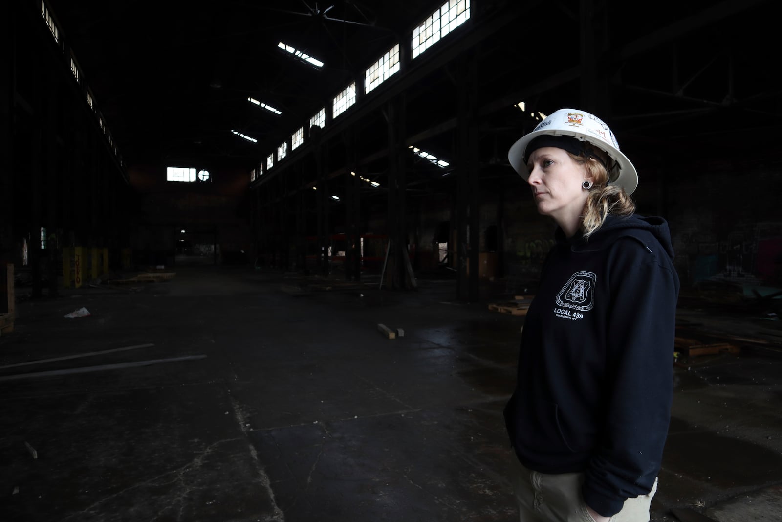 Coalfield Development Crew Chief Ashley Cain stands inside the organization’s empty Black Diamond factory construction project in Huntington, W.Va. on Thursday, Feb. 6, 2025. (AP Photo/Leah Willingham)