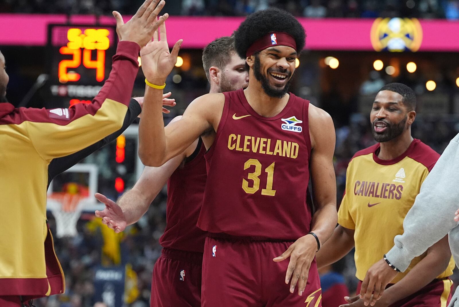 Cleveland Cavaliers center Jarrett Allen is congratulated after scoring a basket against the Denver Nuggets in the first half of an NBA basketball game Friday, Dec. 27, 2024, in Denver. (AP Photo/David Zalubowski)