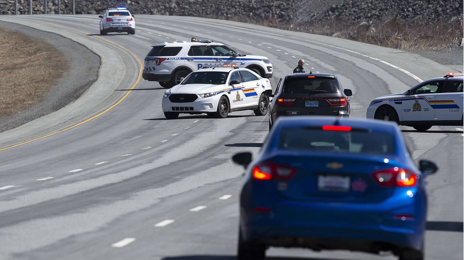 Royal Canadian Mounted Police officers block off a roadway in Enfield, Nova Scotia, Sunday April 19, 2020. A total of 22 people were killed in the deadliest mass shooting in Canada in 30 years. Accused gunman Gabriel Wortman, 51, was killed in a shootout with police.