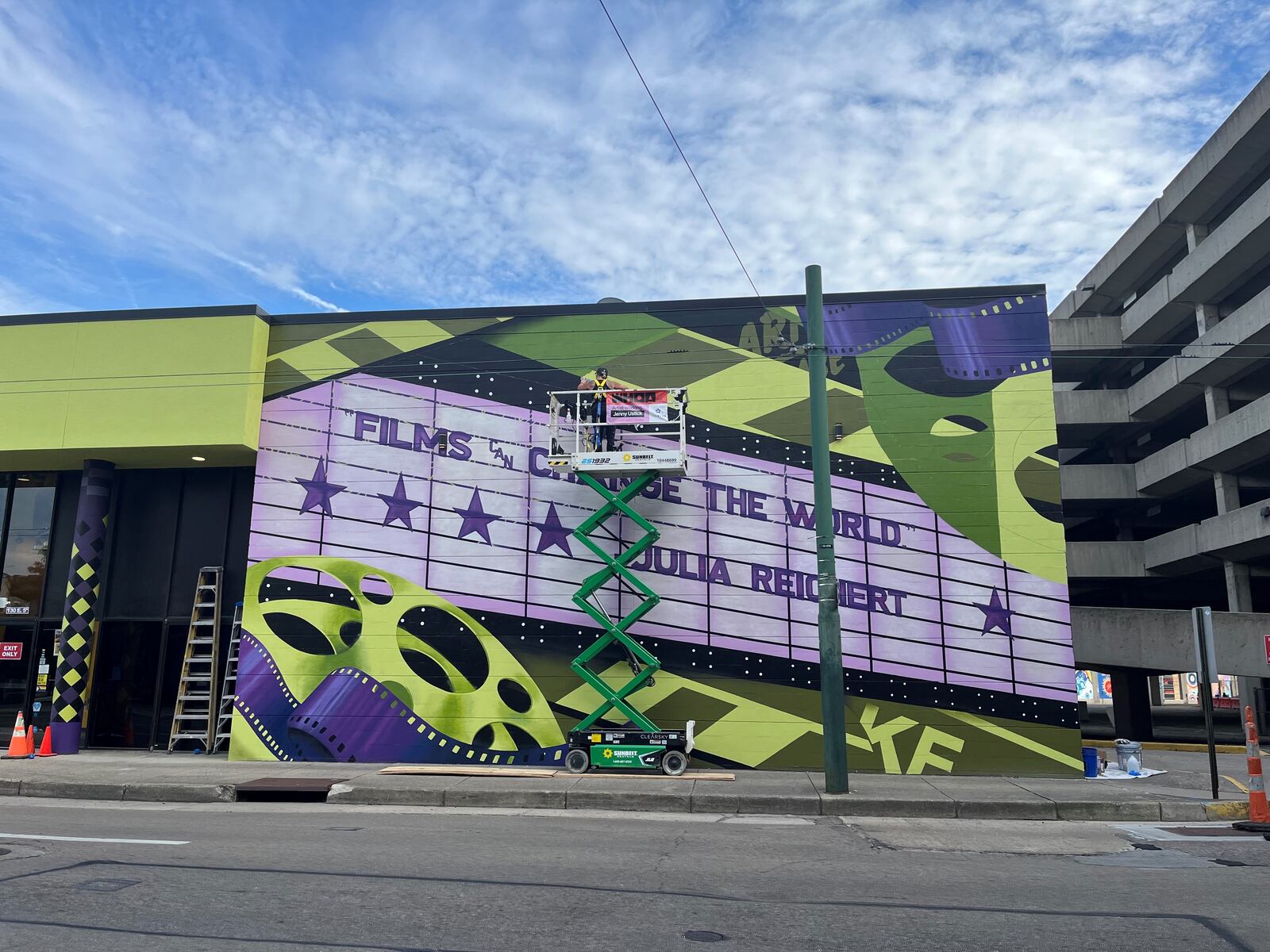 The Neon, an art house cinema in downtown Dayton, has a colorful new exterior. The new mural pays tribute to Julia Reichert, a local, Oscar-winning documentarian. CORNELIUS FROLIK / STAFF