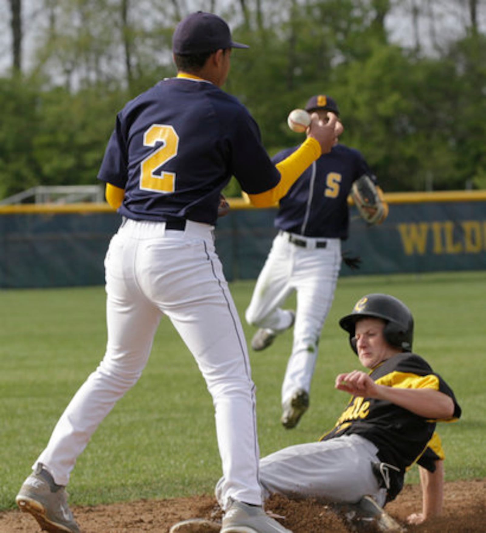 Sean Murphy (2) of Centerville slides in to third base as Derek Williams (2) of Springfield makes the catch during Tuesday's baseball game in Springfield on April 10, 2012.