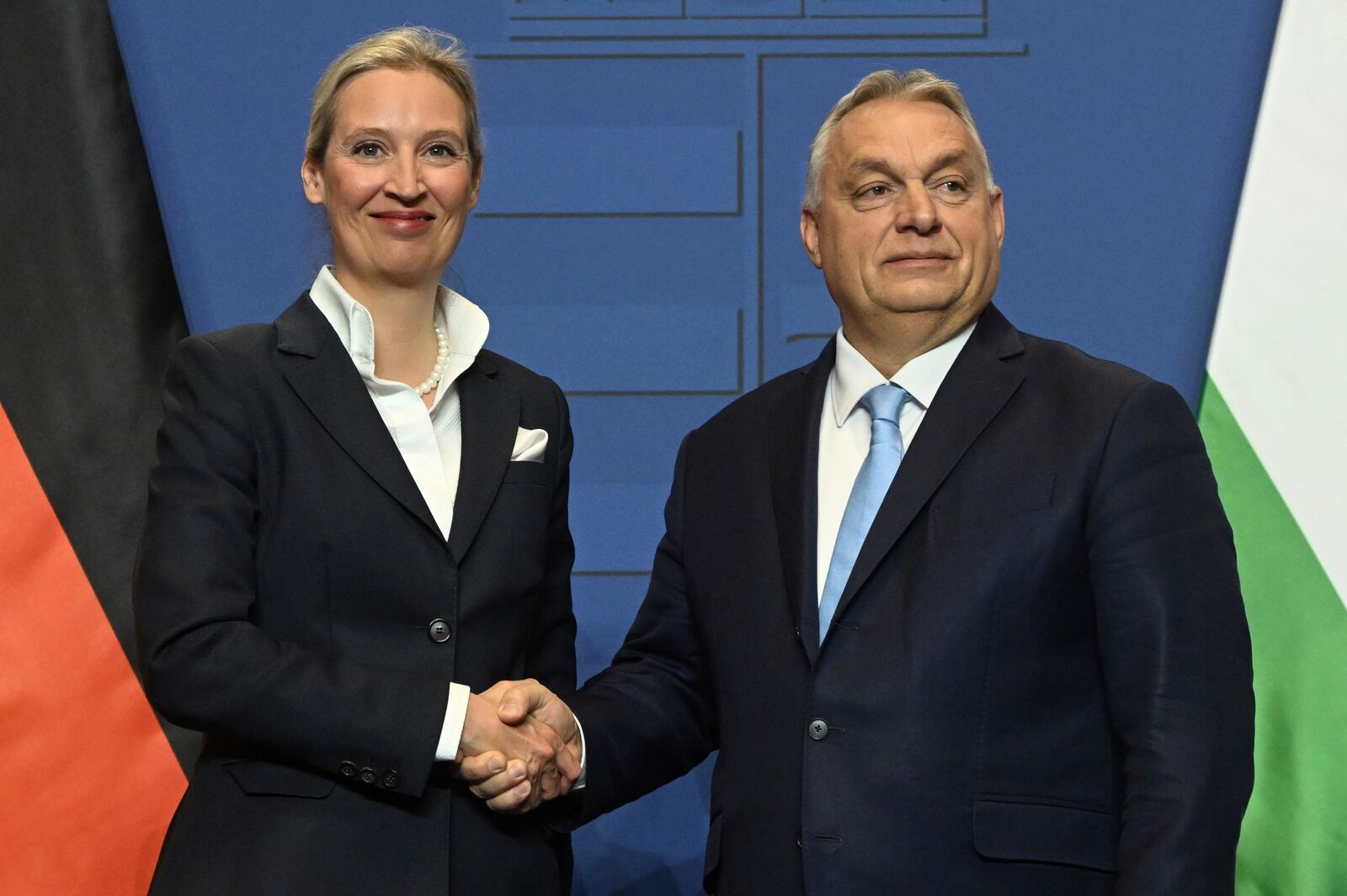 Alice Weidel, the Alternative for Germany (AfD) party's candidate for chancellor, left, and Hungarian Prime Minister Viktor Orban shake hands during a press conference following their meeting in the government headquarters in Budapest, Hungary, Wednesday, Feb. 12, 2025. (Szilard Koszticsak/MTI via AP)