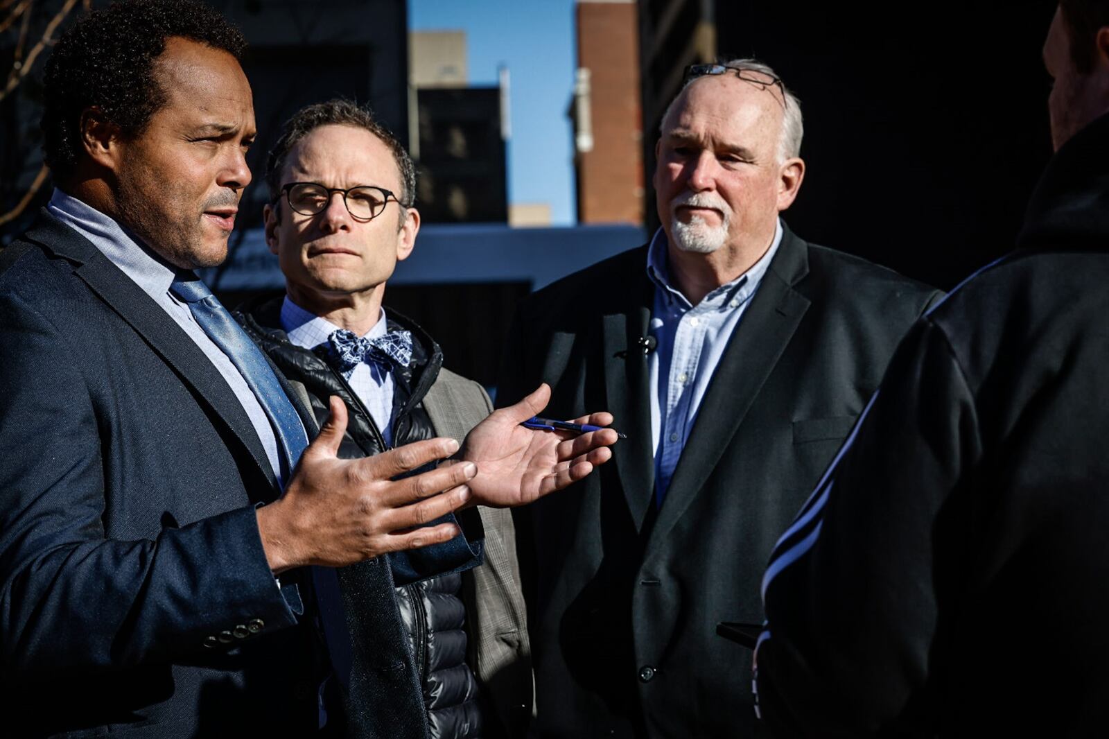 Attorneys David B. Owens, left, and Mike Kanovitz, center, talk with the Dayton Daily News after their client, Dean Gillispie, right, was awarded a $45 million judgment Monday, Nov. 21, 2022, at the federal building in Dayton after he was wrongfully imprisoned for more than 20 years.  JIM NOELKER/STAFF