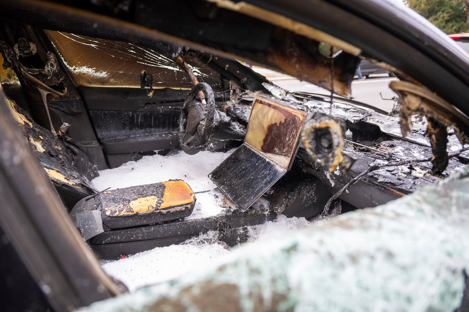 A burnt-out Tesla car stands in the Steglitz district of Berlin, Friday, March 14, 2025, as four Teslas are suspected to have been set on fire in Berlin last night. (Christophe Gateau/dpa via AP)