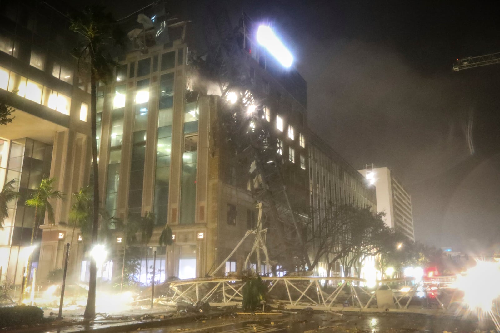 A crane falls onto a building along 1st Avenue South in St. Petersburg, Fla., as Hurricane Milton's strong winds tore through the area Thursday, Oct. 10, 2024. (Chris Urso/Tampa Bay Times via AP)