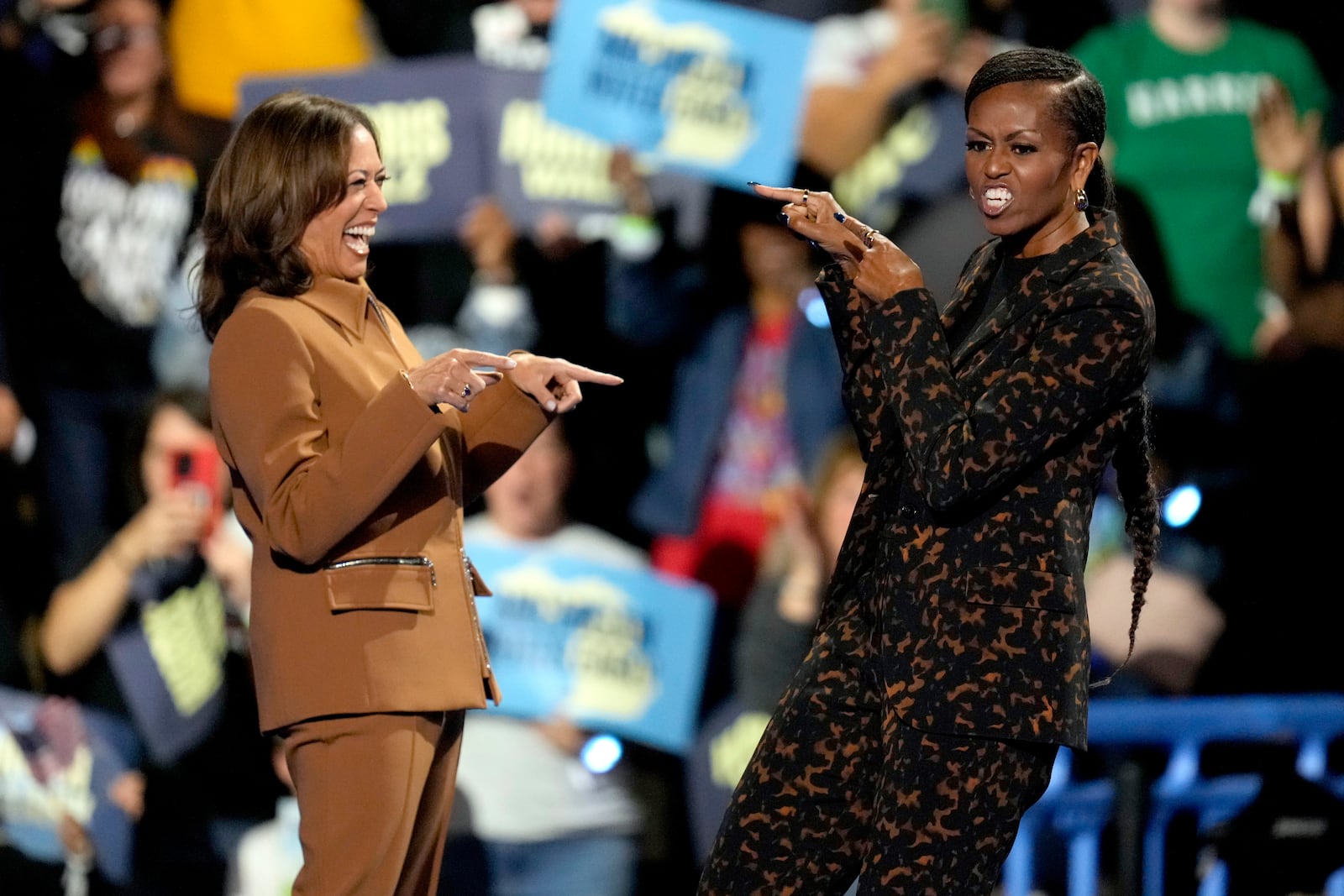 Democratic presidential nominee Vice President Kamala Harris, left, and former first lady Michelle Obama arrive to speak at a campaign rally at the Wings Event Center, Saturday, Oct. 26, 2024, in Kalamazoo, Mich. (AP Photo/Paul Sancya)