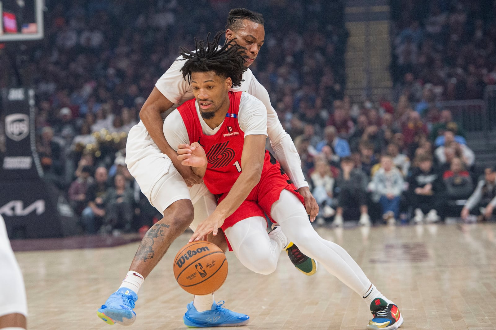 Portland Trail Blazers' Shaedon Sharpe, front, tries to get past Cleveland Cavaliers' Darius Garland, back, during the first half of an NBA basketball game in Cleveland, Sunday, March 2, 2025. (AP Photo/Phil Long)