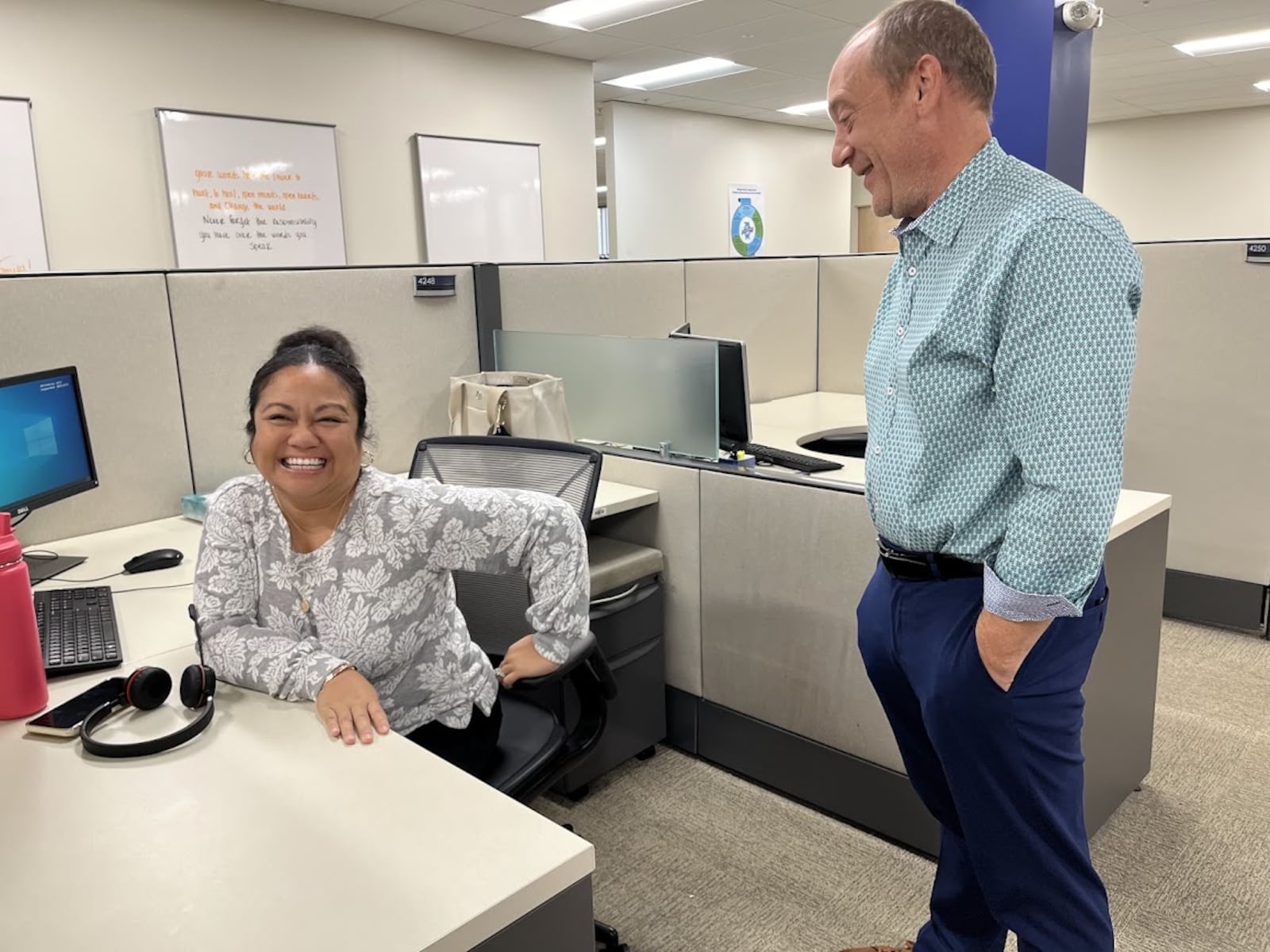 Timothy Mislansky, president and chief executive of Wright Patt Credit Union Inc. speaks with Kristine Massie, who works in the credit union's Beavercreek member help center. THOMAS GNAU/STAFF