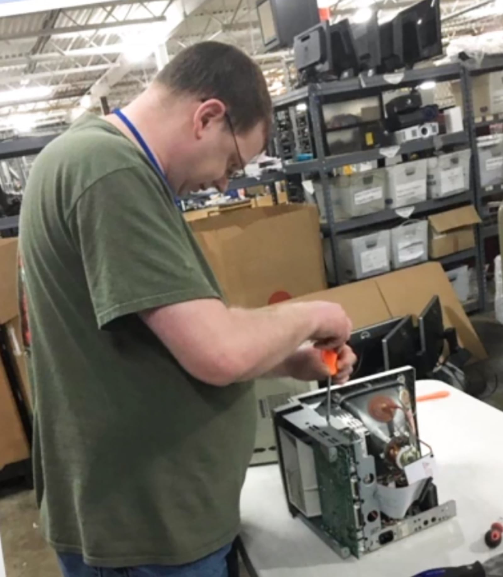 Rizer taking apart a computer to recycle it for parts. He said he has always had an interest in technology and computers.