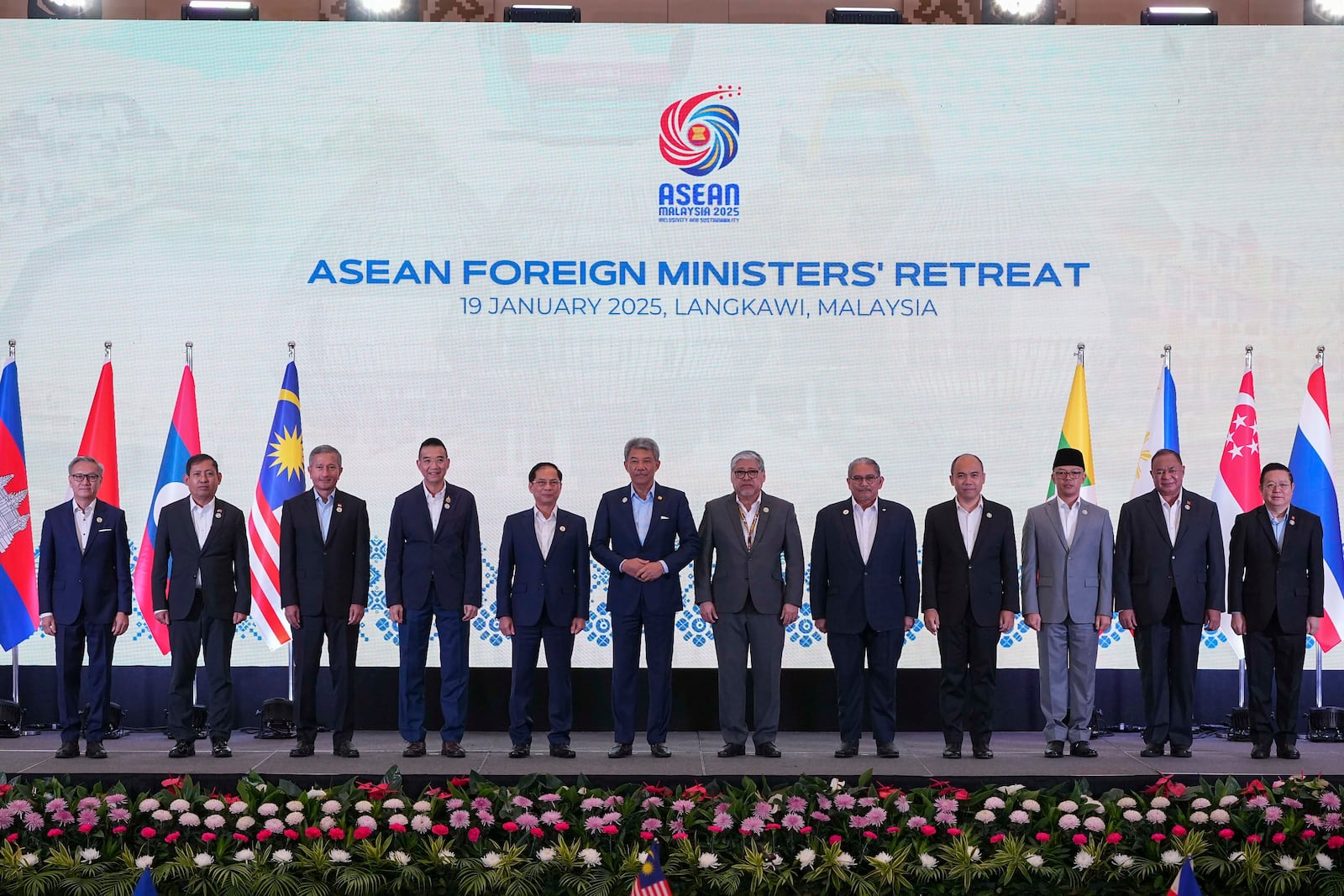 From left to right, Laos's Foreign Affairs Minister Thongsavanh Phomvihane, Myanmar's Permanent Secretary to ASEAN Aung Kyaw Moe, Singapore's Foreign Minister Vivian Balakrishnan, Thailand's Foreign Minister Maris Sangiampongsa, Vietnam's Foreign Minister Bui Thanh Son, Malaysia's Foreign Minister Mohamad Hasan, Philippines's Foreign Affairs Secretary Enrique Manalo, Brunei Darussalam Foreign Minister Erywan Yusof, Cambodia's Secretary of State Kung Phoak, Indonesia's Foreign Minister Sugiono, East Timor's Foreign Minister Bendito Freitas and ASEAN Secretary General Kao Kim Hourn pose for a group photo during the Association of Southeast Asian Nations (ASEAN) Foreign Ministers' Retreat in Langkawi Island, Malaysia, Sunday, Jan. 19, 2025. (AP Photo/Azneal Ishak, Pool)