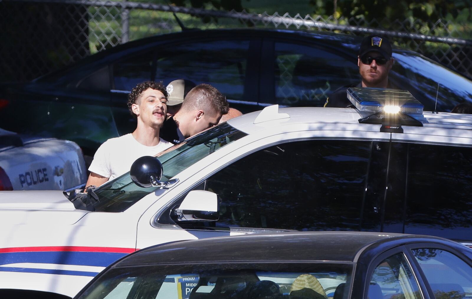 Jaden Thomas is taken into custody Wednesday by Middletown Police for allegedly firing a gun from an apartment window at a person in car below. NICK GRAHAM/STAFF