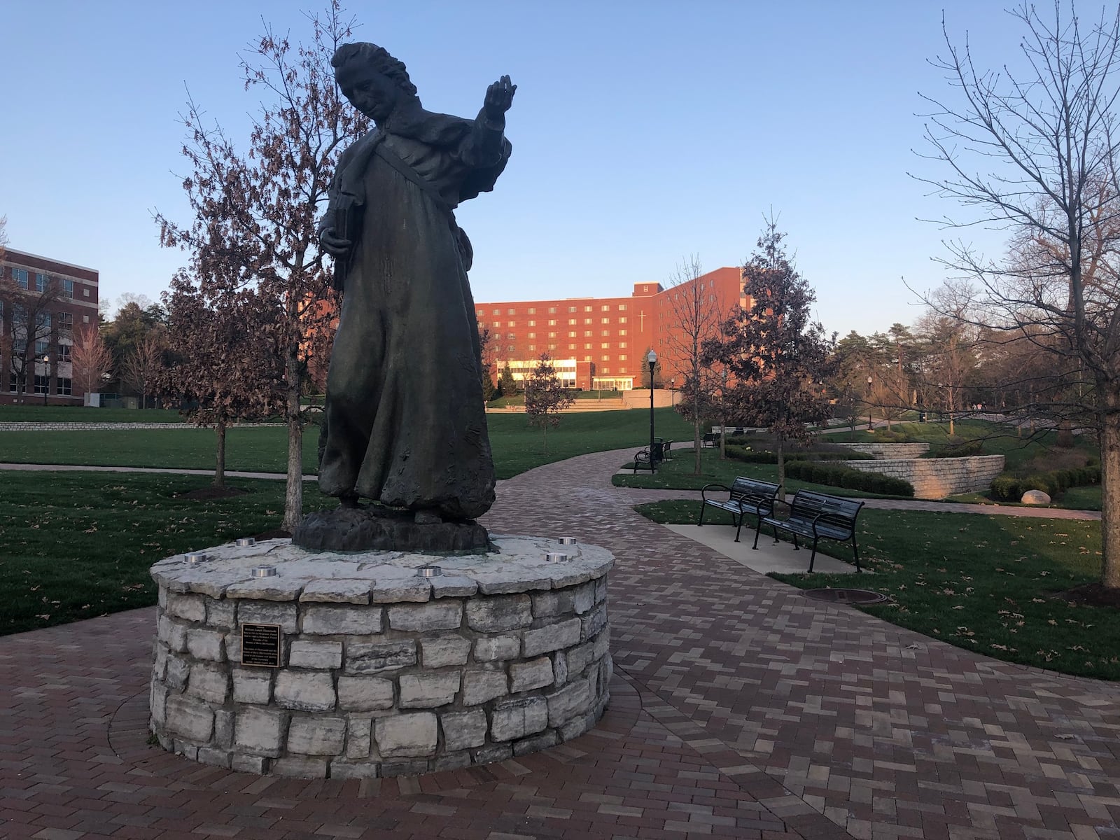 A statute of Marianist founder William Chaminade on the University of Dayton campus. Residence halls, like the Marycrest Complex in the background, are almost empty due to coronavirus-related closures. JEREMY P. KELLEY / STAFF