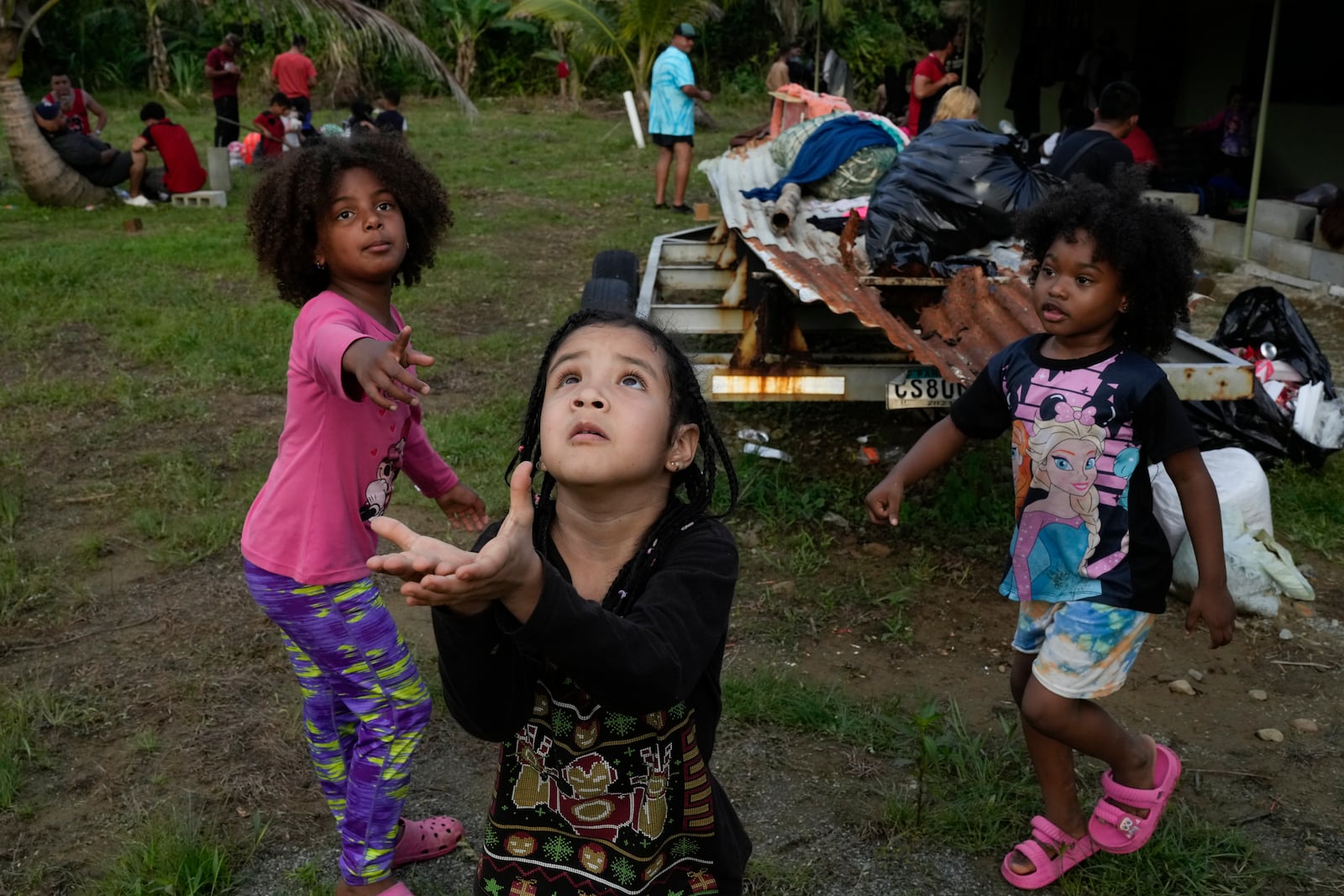 Children of Venezuelan migrants play ball in Puerto Cartí, on Panama's Caribbean coast, Saturday, Feb. 22, 2025, where their families are camping out before boarding boats to Colombia on their way back from southern Mexico after giving up hopes of reaching the U.S. amid President Trump's crackdown on migration. (AP Photo/Matias Delacroix)