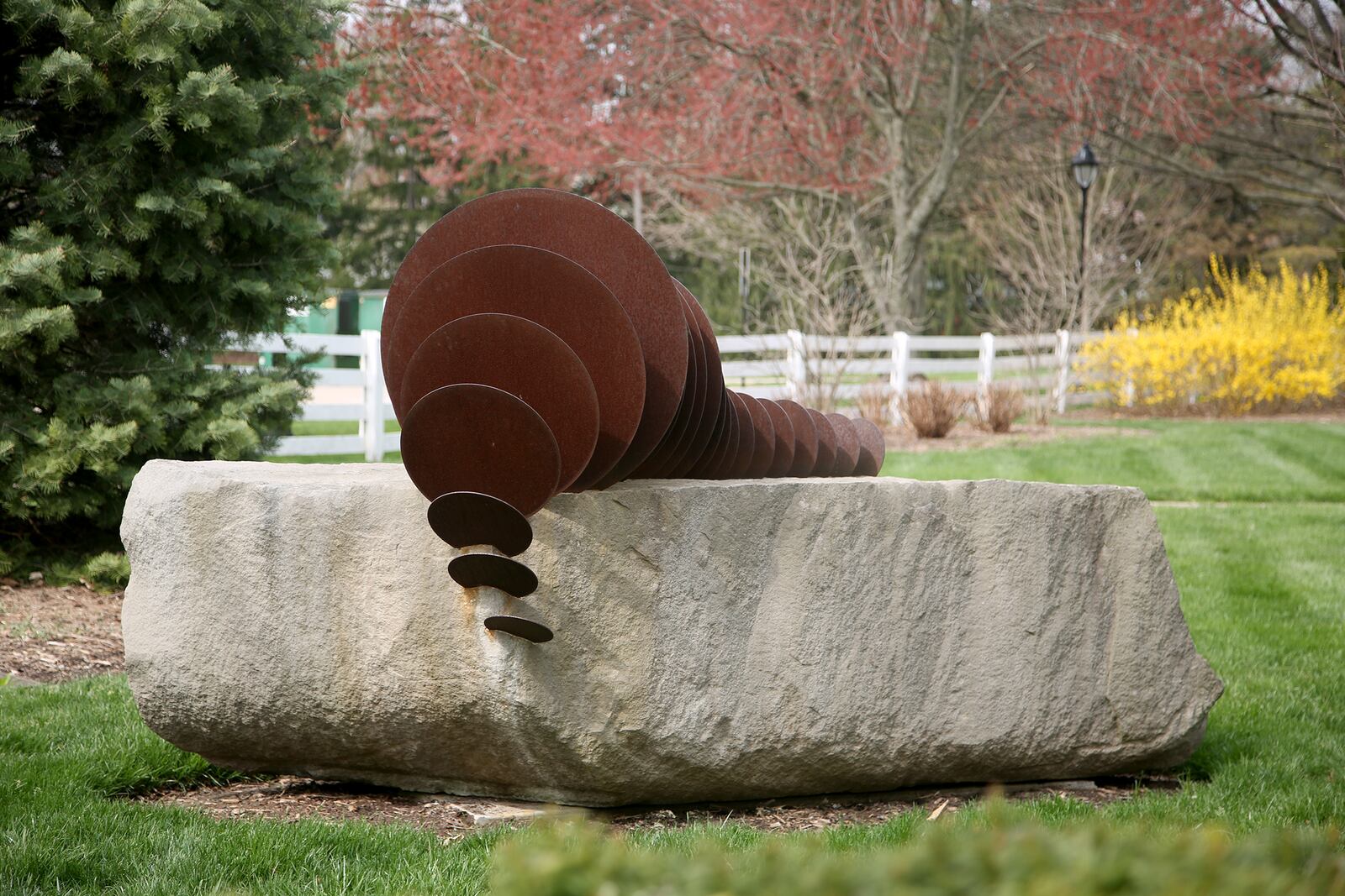 "The Interior Animal," a work created by artist Erika Inger, is formed from rough-cut block of stone untouched from the quarry. Metal discs in descending sizes resemble a backbone shape and will make a music tone if fanned by hand. LISA POWELL / STAFF