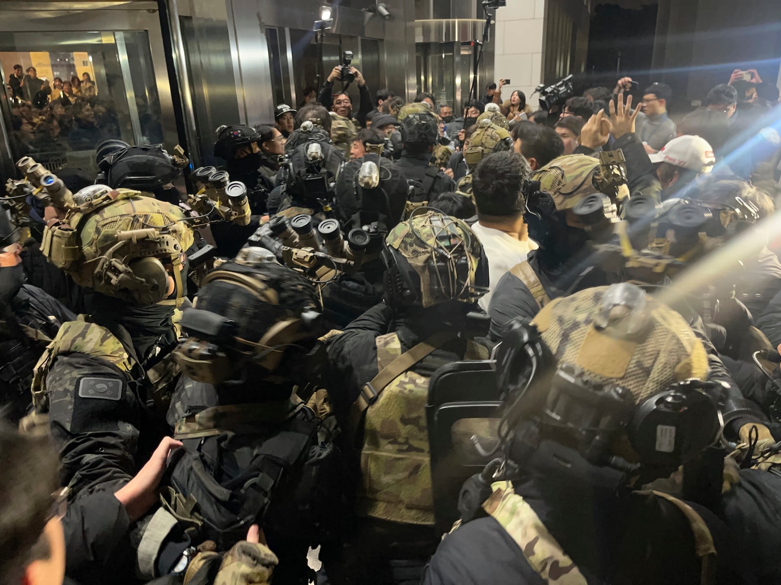 South Korean martial law soldiers try to enter the National Assembly compound in Seoul, South Korea, Wednesday, Dec. 4, 2024. (Cho Jung-woo/Newsis via AP)