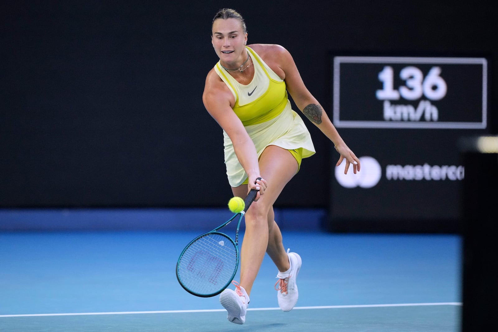 Aryna Sabalenka of Belarus plays a forehand return to Sloane Stephens of the U.S. during their first round match at the Australian Open tennis championship in Melbourne, Australia, Sunday, Jan. 12, 2025. (AP Photo/Vincent Thian)