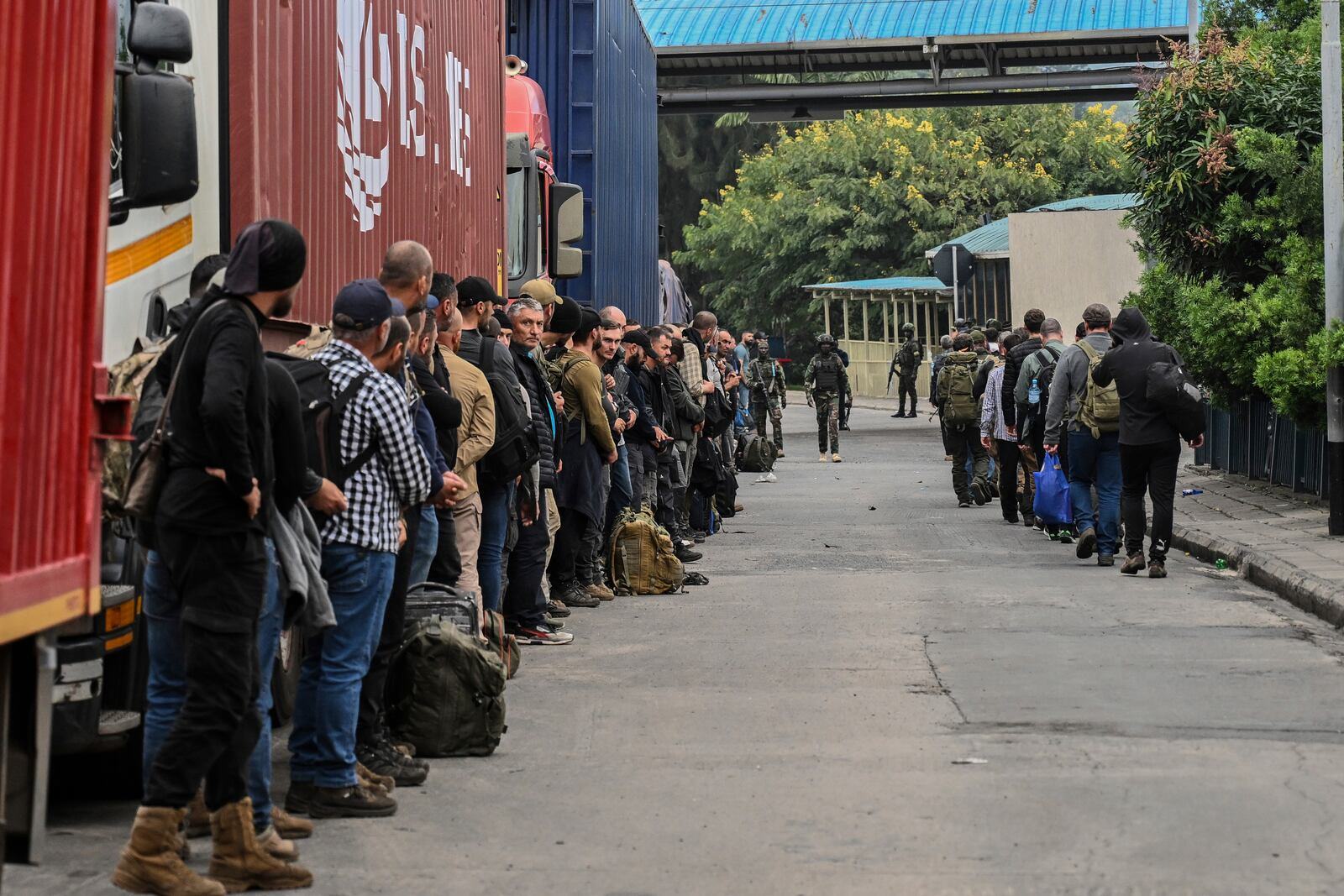 Romanian mercenaries line up to cross the border into Rwanda in Goma, Democratic Republic of Congo, Wednesday, Jan. 29, 2025.(AP Photo/Moses Sawasawa)