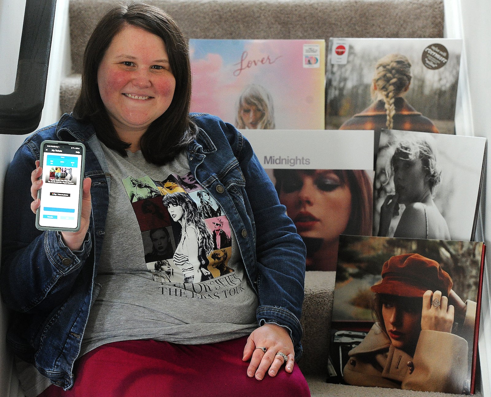 Taylor Swift fan Stacy Kenney of Huber Heights holds up her ticket to the upcoming Cincinnati concert. MARSHALL GORBY\STAFF