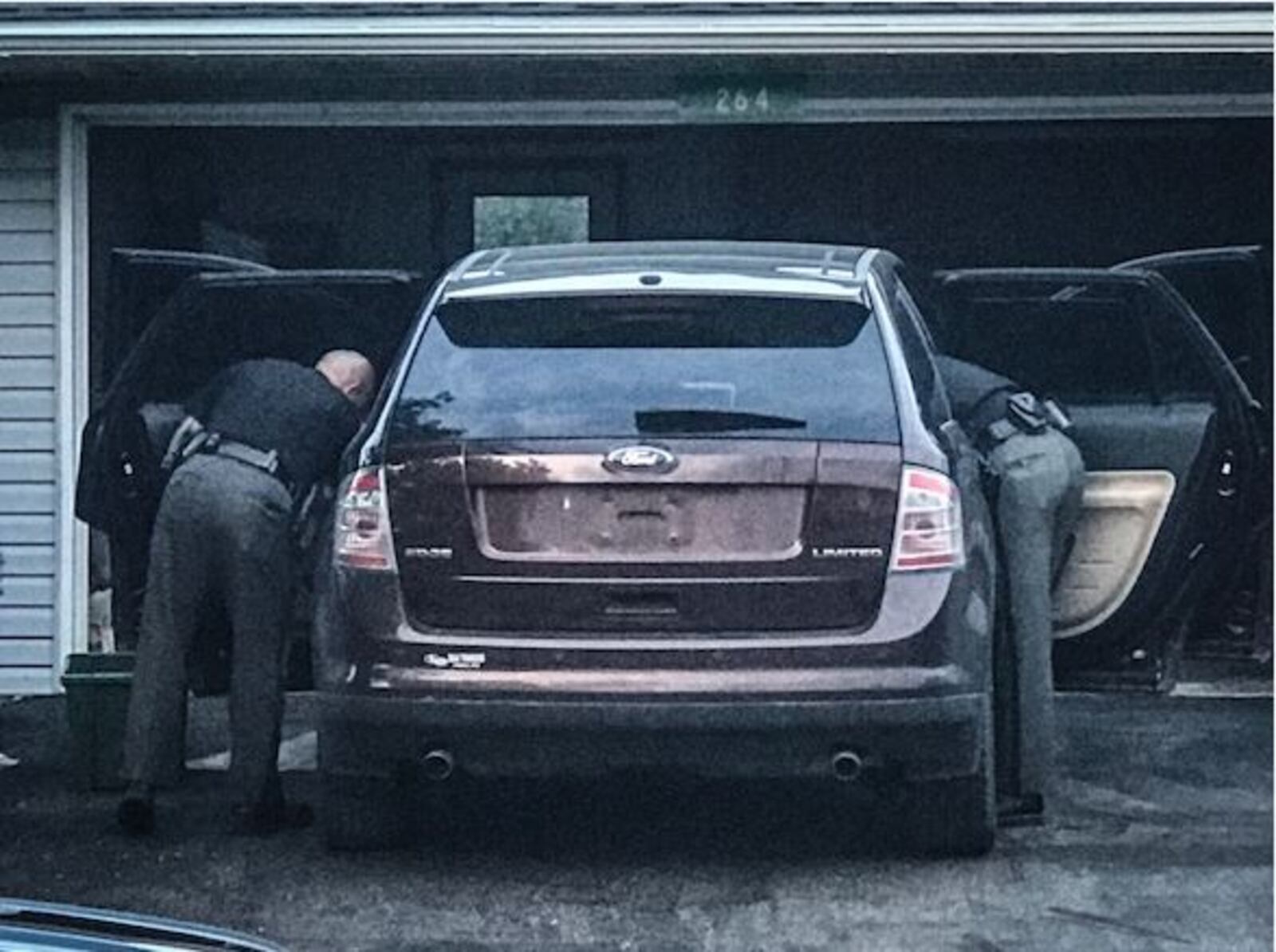 Two Clark County Sheriff's deputies search an SUV on Tuesday evening, May 29, 2018, where a third deputy was overcome when he handled two capsules containing a white powder found in the vehicle earlier in the evening. (Jim Noelker/Staff)