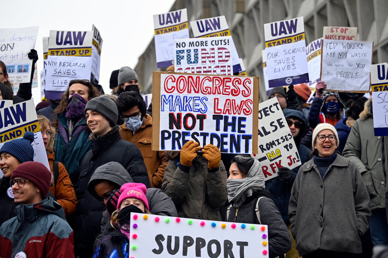 Medical researchers from various universities and the National Institutes of Health rally at Health and Human Services headquarters to protest federal budget cuts Wednesday, Feb. 19, 2025, in Washington. (AP Photo/John McDonnell)