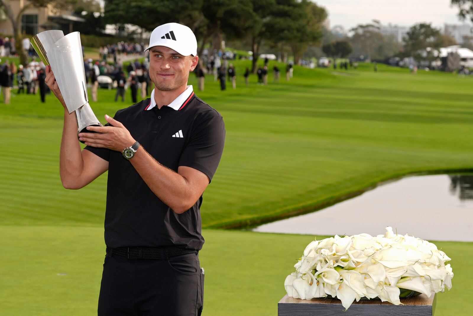 Ludvig Åberg, of Sweden, poses with the trophy after winning the Genesis Invitational golf tournament Sunday, Feb. 16, 2025, in San Diego. (AP Photo/Gregory Bull)