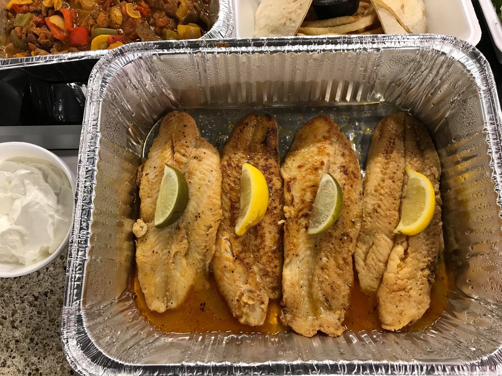 El Meson is among the restaurants offering carryout and curbside serve.   Filet of fish for four is pictured.