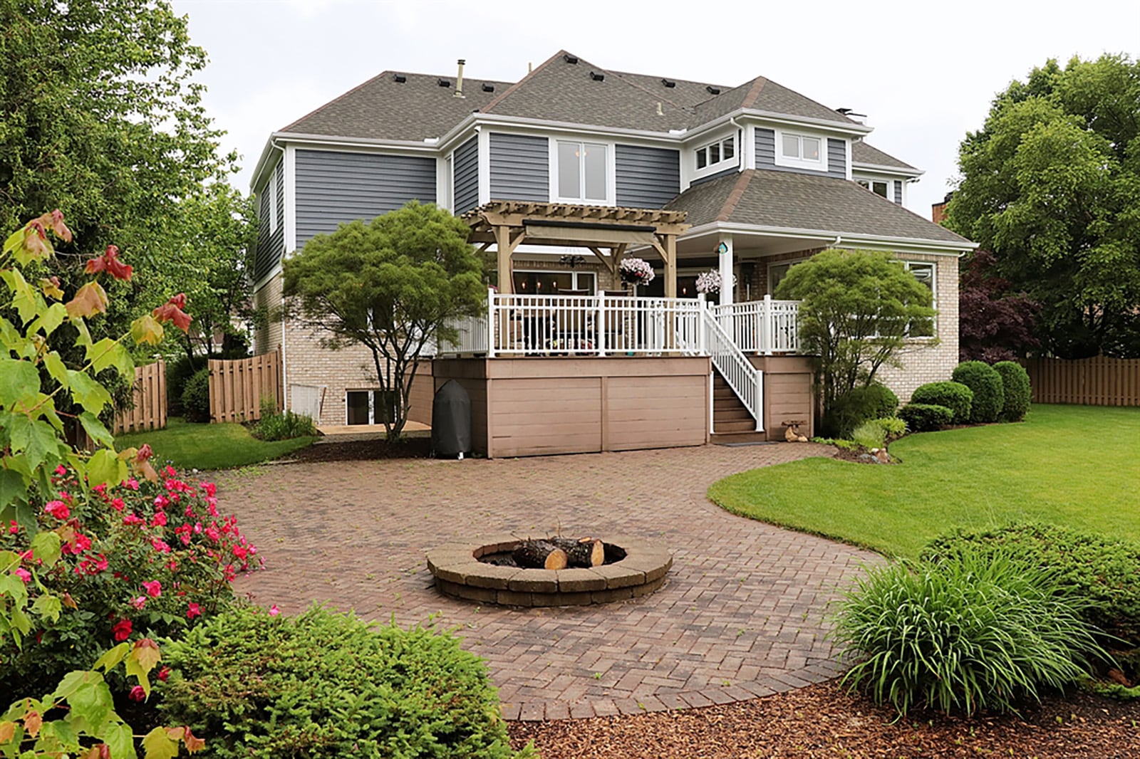 The breakfast room has triple patio doors with a transom that opens to a composite deck with vinyl railings. Steps lead down to the back yard, which has a paver-brick patio with a fire pit, playset area and tailored landscaping. CONTRIBUTED PHOTO BY KATHY TYLER