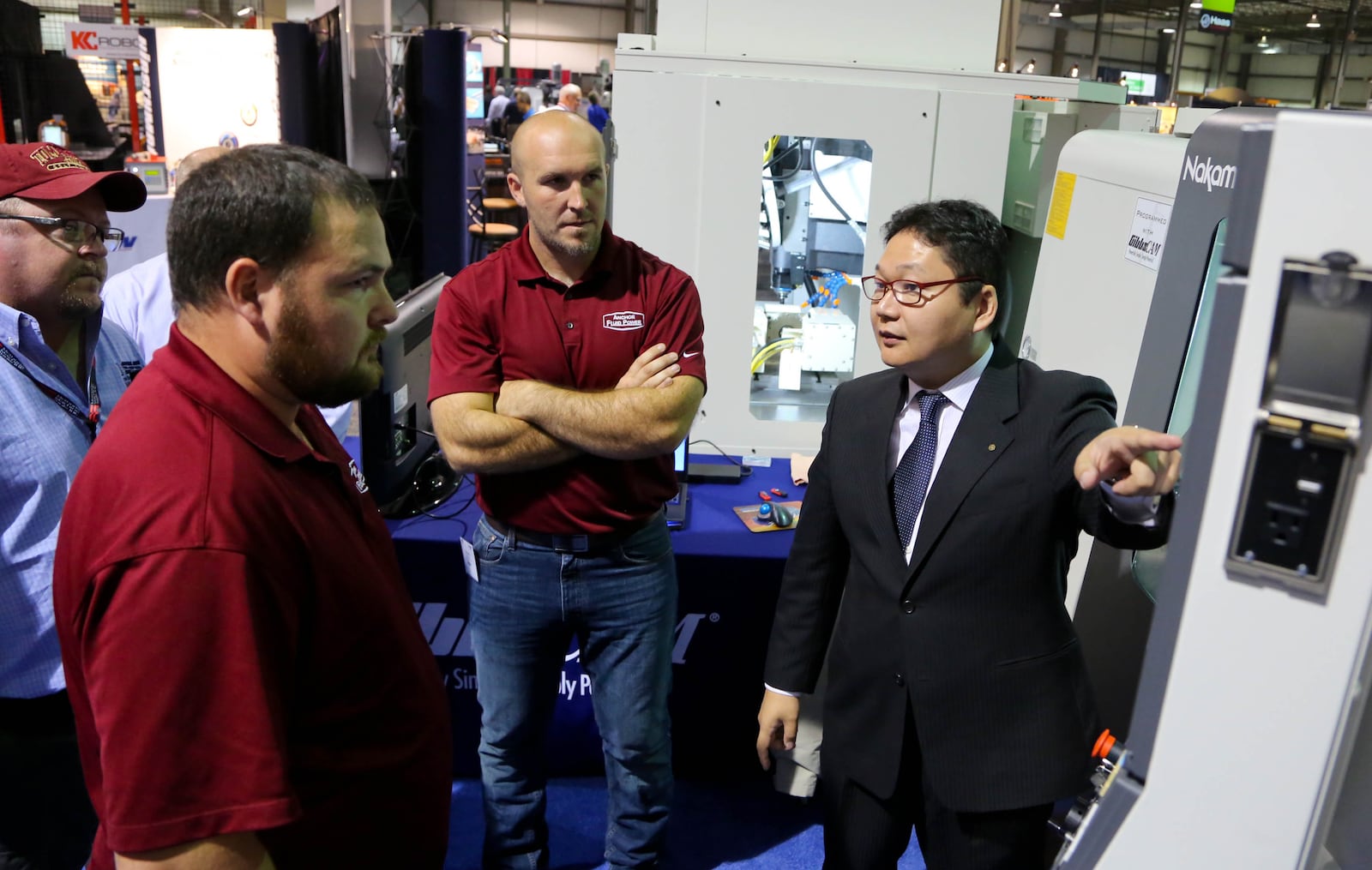 Nakamura-Tome Product Manager Jundi Oyama demonstrates a CNC Multi-Axis Mill Turn Machine at the 2015 DRMA Advanced Manufacturing and Technology Trade Show. JIM WITMER/STAFF