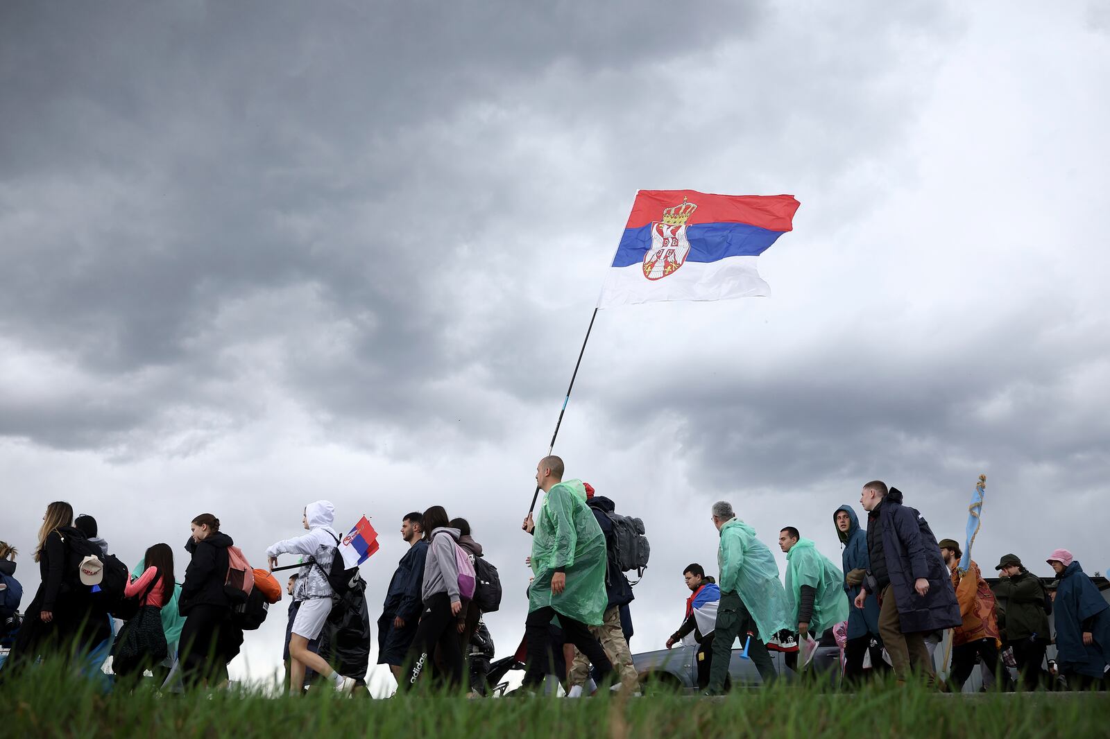 Students and anti-government protesters march towards Belgrade for a joint protest after a break in Cortanovci, Serbia, Thursday, March 13, 2025. (AP Photo/Armin Durgut)