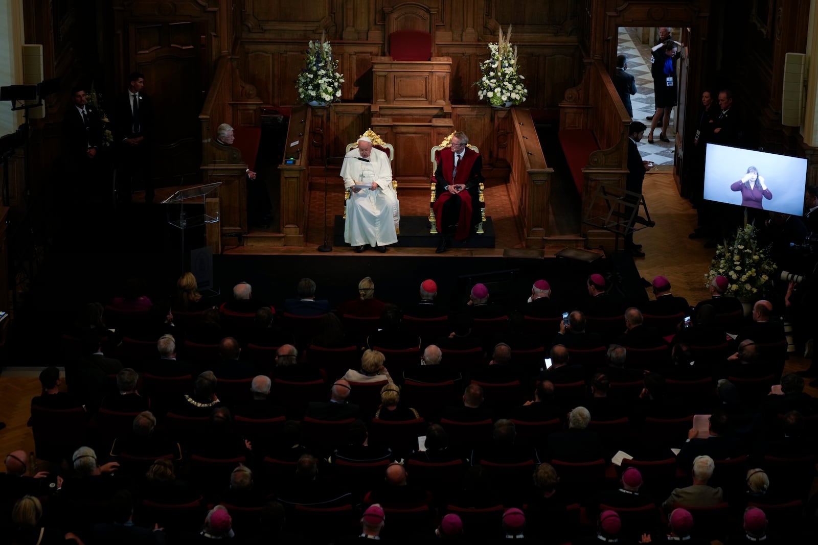 Pope Francis, left, flanked by Rector Luc Sels, delivers his speech during his meeting with the professors in the Promotiezaal of the Catholic University of Leuven, Belgium, Friday, Sept. 27, 2024. (AP Photo/Andrew Medichini)