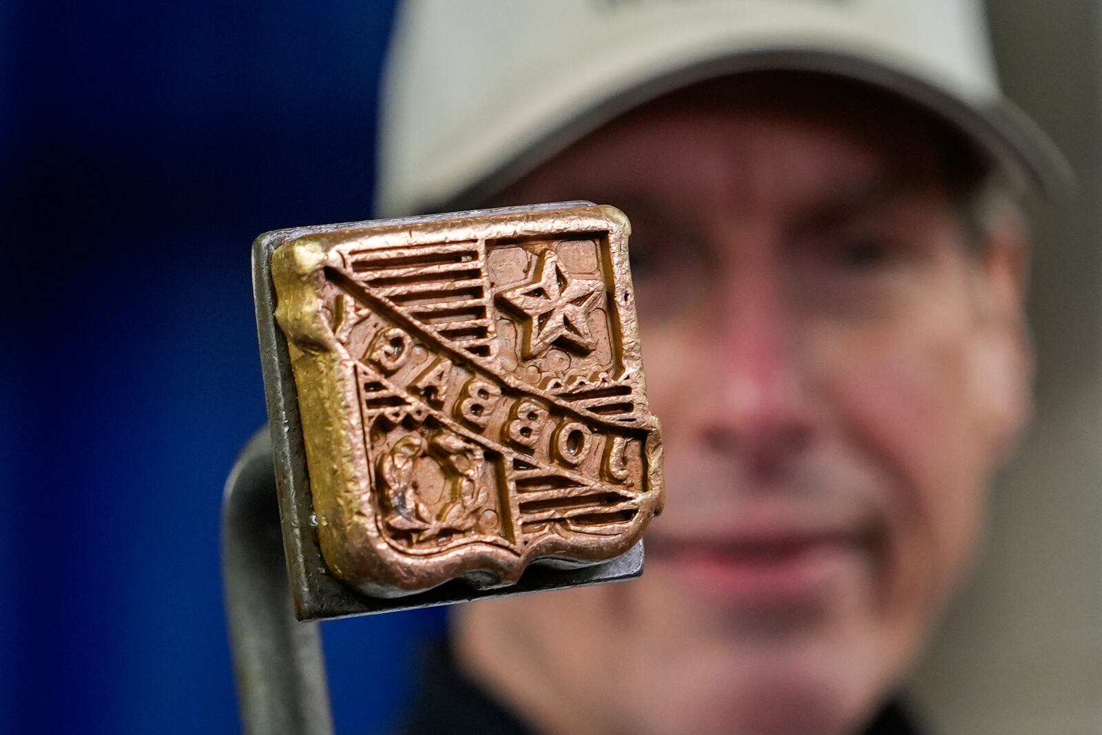 John Jobbagy shows his stamp on a cut of beef during an interview at J.T. Jobbagy Inc. in the Meatpacking District of Manhattan, Tuesday, Nov. 19, 2024, in New York. (AP Photo/Julia Demaree Nikhinson)