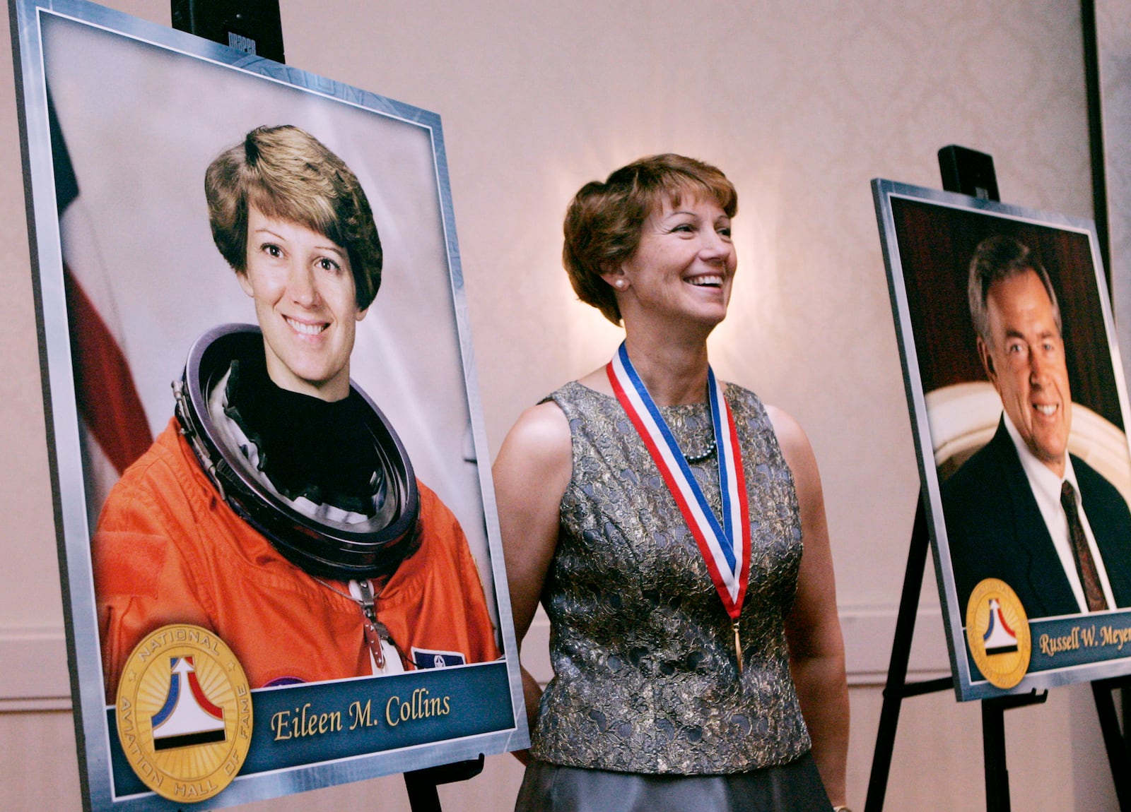 Eileen Collins stads next to a portait of herself as she has her picture taken. This is a scene from the National Aviation Hall of Fame photo reception. The event was held for aviation figures who are to be enshrined in the organization's hall of fame. The party was held in the Crowne Plaza Hotel, in downtown Dayton. Collins commanded STS 114, a space shuttle mission.