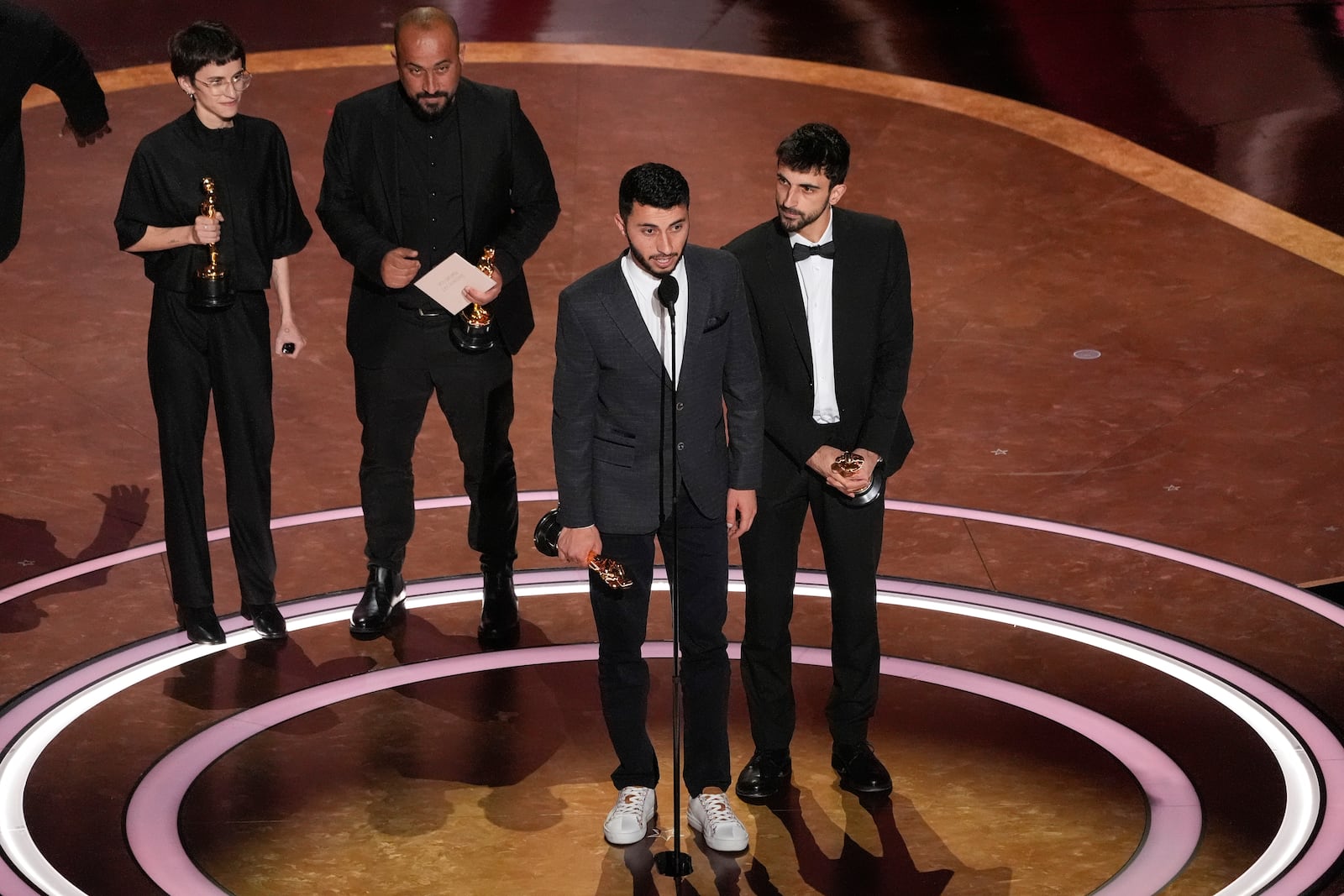 Rachel Szor, from left, Hamdan Ballal, Basel Adra, and Yuval Abraham accept the award for best documentary feature film for "No Other Land" during the Oscars on Sunday, March 2, 2025, at the Dolby Theatre in Los Angeles. (AP Photo/Chris Pizzello)