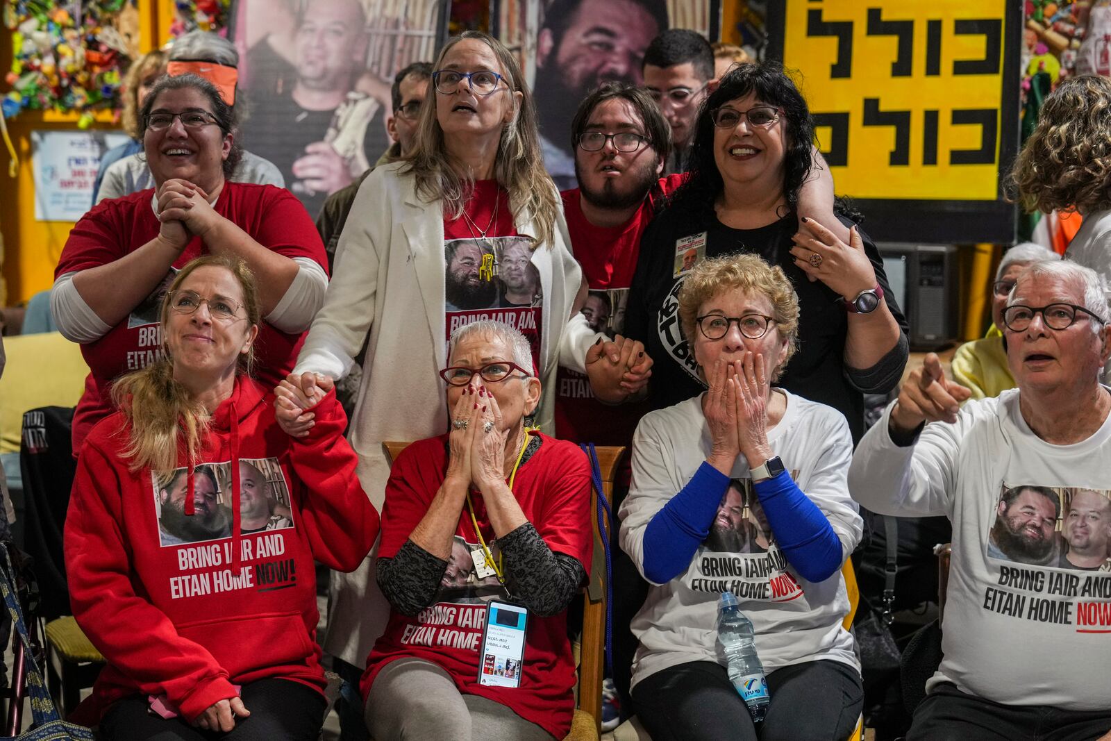 Friends of Iair Horn watch a live Gaza broadcast of his release from Hamas captivity during a gathering in Kfar Saba, Israel, Saturday, Feb. 15, 2025. (AP Photo/Ariel Schalit)