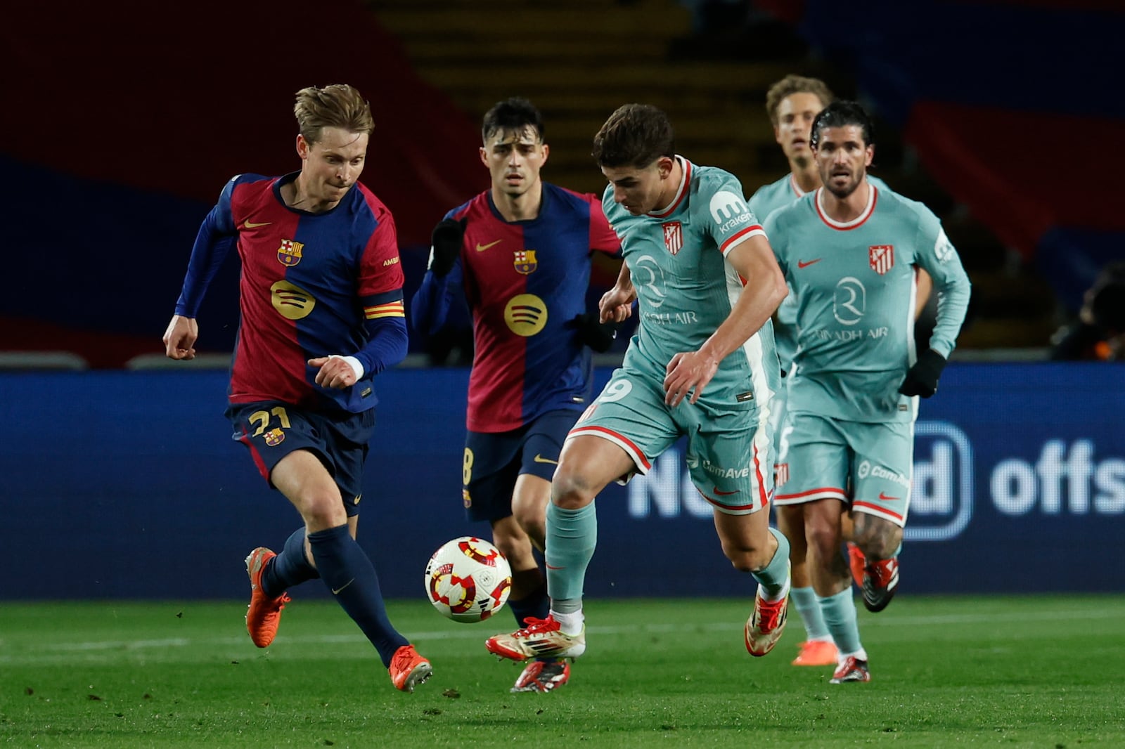 Barcelona's Frenkie de Jong, left, and Atletico Madrid's Julian Alvarez run for the ball during a Spanish Copa del Rey, or King's Cup, the semi-final soccer match between Barcelona and Atletico Madrid in Barcelona, Spain, Tuesday, Feb. 25, 2025. AP Photo/Joan Monfort)