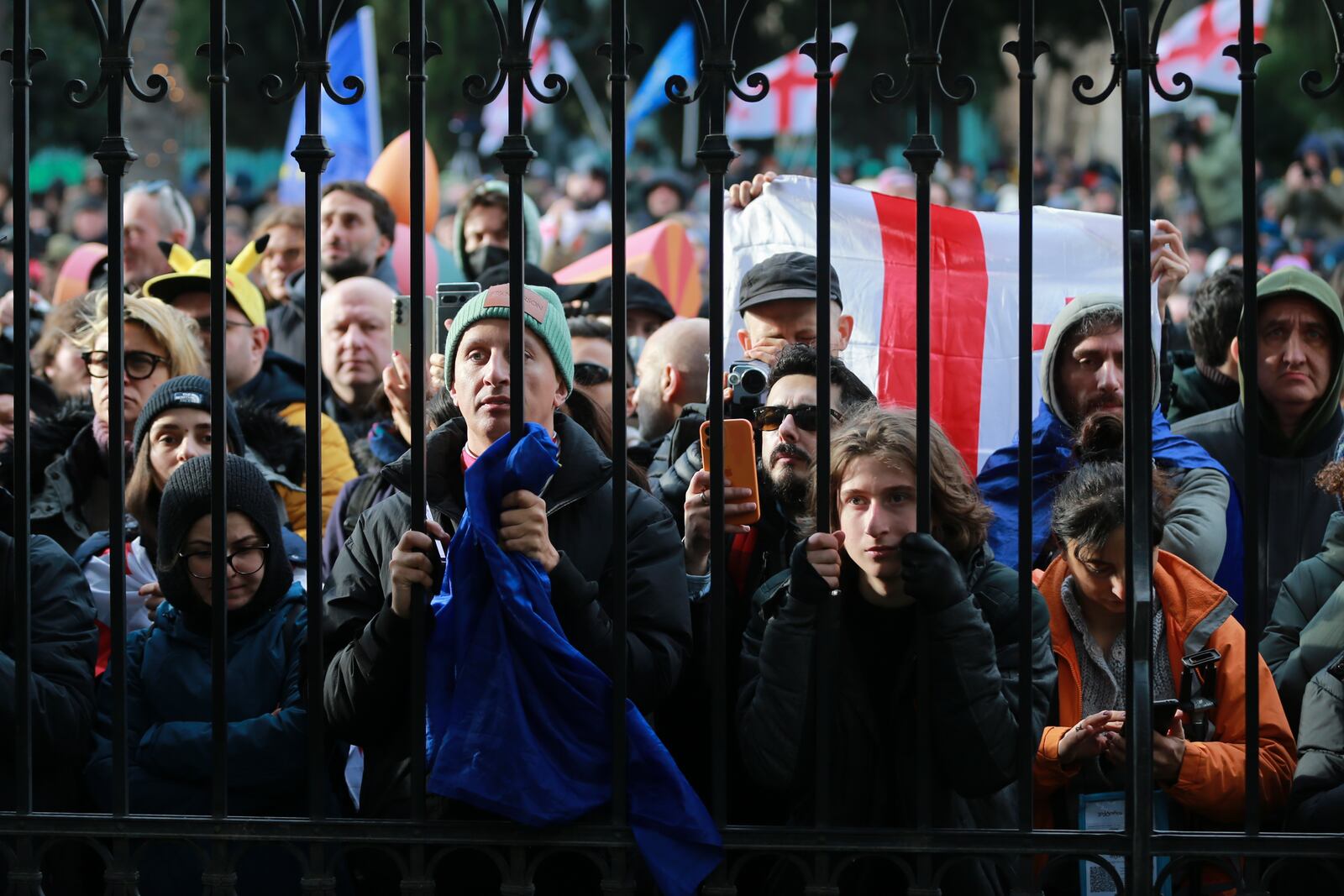 People listen to outgoing Georgian President Salome Zourabichvili speaking outside of the Orbeliani Palace, the official residence of the President of Georgia, in Tbilisi, Georgia, Sunday, Dec. 29, 2024. (AP Photo/Zurab Tsertsvadze)