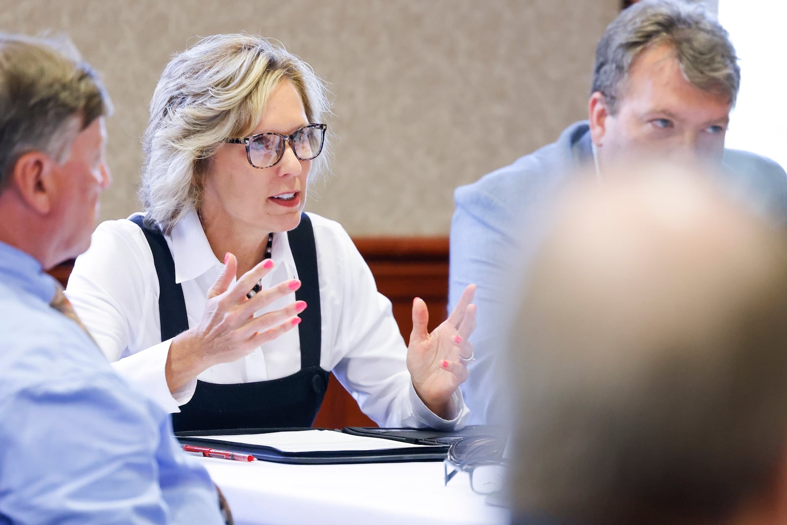 Butler County Auditor Nancy Nix is hosting a property tax forum where lawmakers and county officials can address the new bills introduced this year (2025) in the Ohio General Assembly. Pictured is Nix during the June 2024 property tax summit talking with state and local elected officials. NICK GRAHAM/FILE 