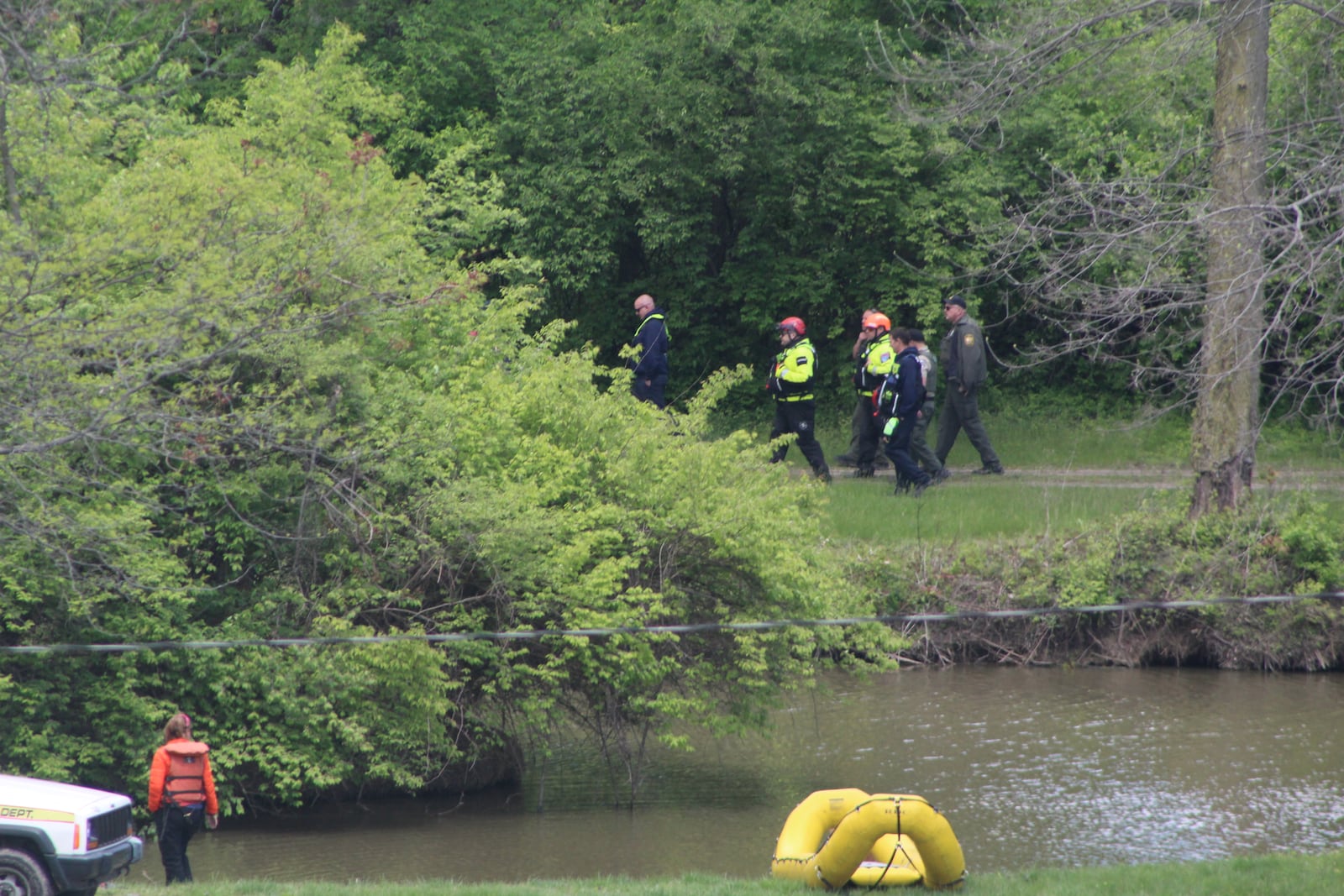 Search and rescue personnel walk along a body of water near the Mad River well field area near Eastwood MetroPark. Crews are searching for a 7-year-old boy who went missing Saturday evening. CORNELIUS FROLIK / STAFF