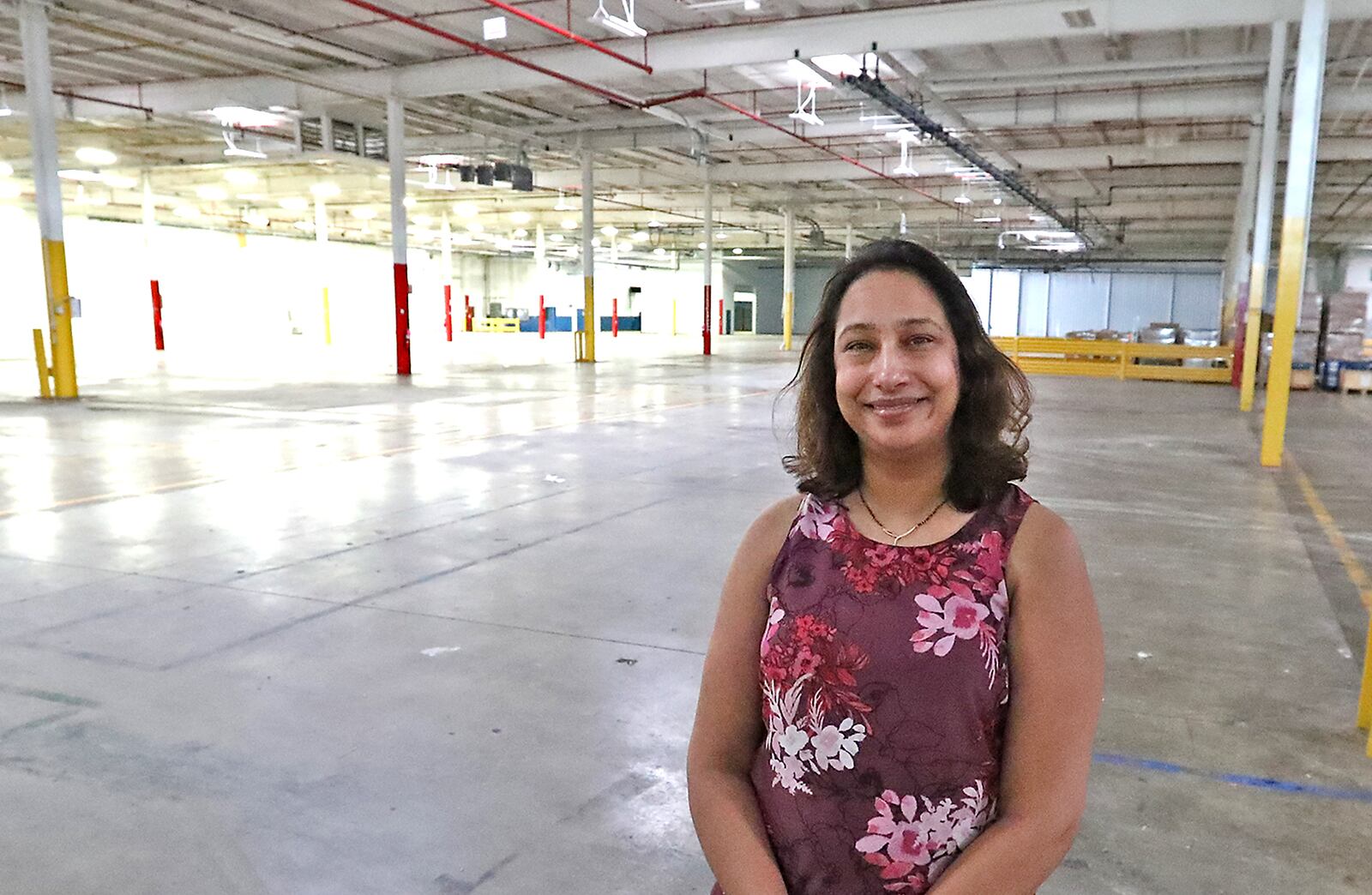 Shalini Sheth, director of operations for Surati, in the empty plant her company will move into soon on Upper Valley Pike. BILL LACKEY/STAFF