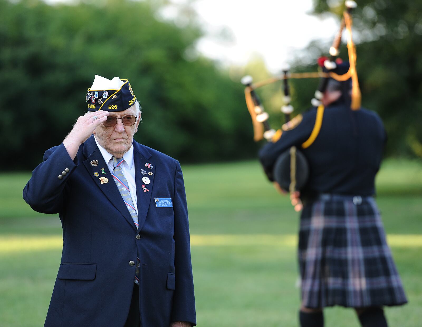 Al Eurlingane salutes as retired Montgomery County Sheriff's Office Sgt. Del Braund played "Amazing Grace" on the bagpipes during the 20th annual 9/11 Memorial Ceremony in Fairborn Saturday, Sept. 11, 2021. MARSHALL GORBY/STAFF