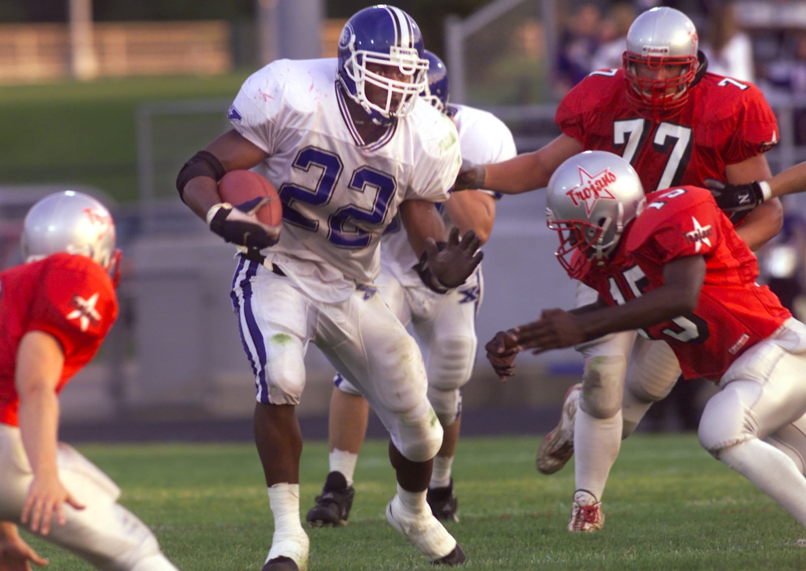 Xenia #22 Trent Cole prepares to ward off Troy #15(WHO IS NOT ON THE ROSTER) and #77 Kris Mick during the first quarter. He made it to the 47 yard line, 2 down, and 6 to go.