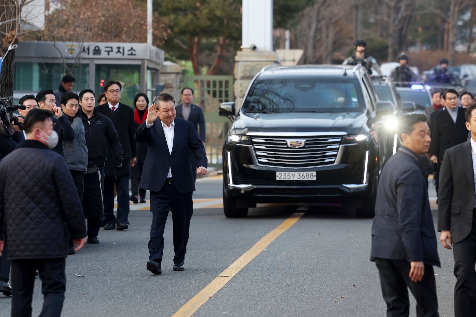 Impeached South Korean President Yoon Suk Yeol greets to his supporters after he came out of a detention center in Uiwang, South Korea, Saturday, March 8, 2025. (Hong Hyo-shik/Newsis via AP)