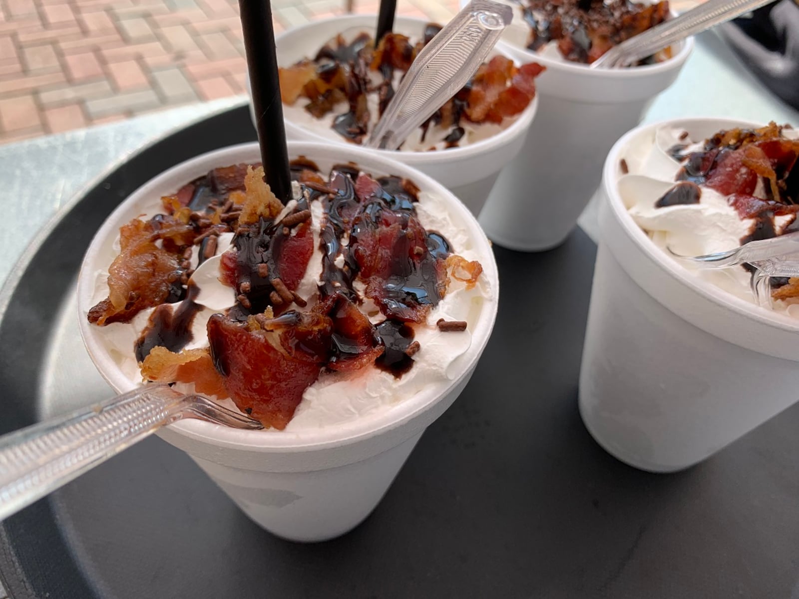 Delicious dishes served at Bacon Fest at Kettering Fraze Pavilion have included pulled pork bacon nachos, bacon banana cream pudding, bacon wrapped turkey legs and Cuban sandwiches. CONTRIBUTED/ALEXIS LARSEN