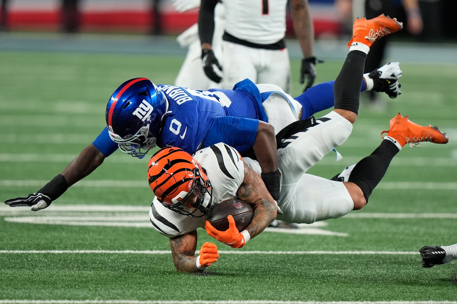 New York Giants linebacker Brian Burns (0) tackles Cincinnati Bengals running back Chase Brown during the second half of an NFL football game, Sunday, Oct. 13, 2024, in East Rutherford, N.J. (AP Photo/Frank Franklin II)