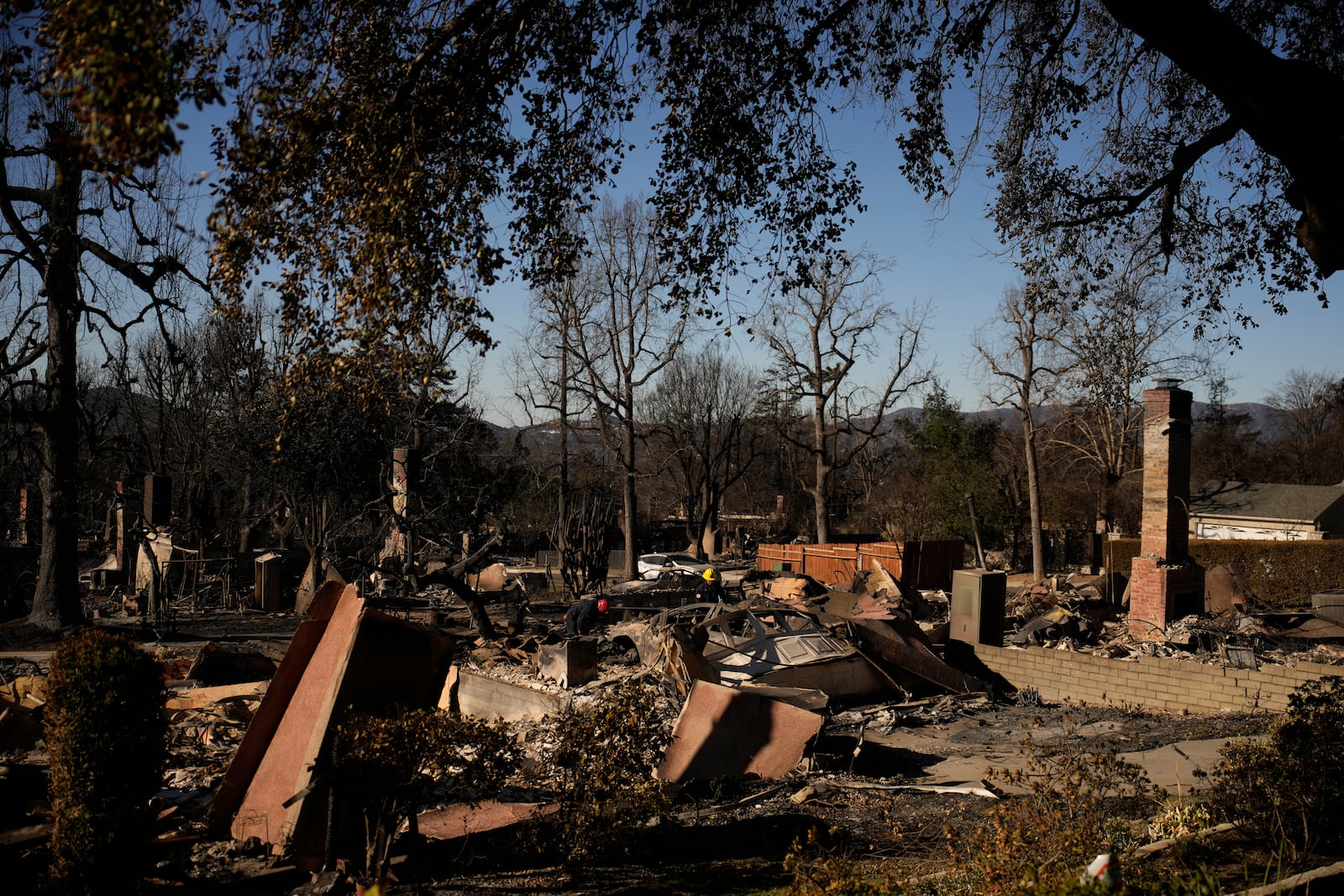 Search and rescue crew inspect homes destroyed by the Eaton Fire in in Altadena, Calif., is seen Wednesday, Jan 15, 2025. (AP Photo/John Locher)