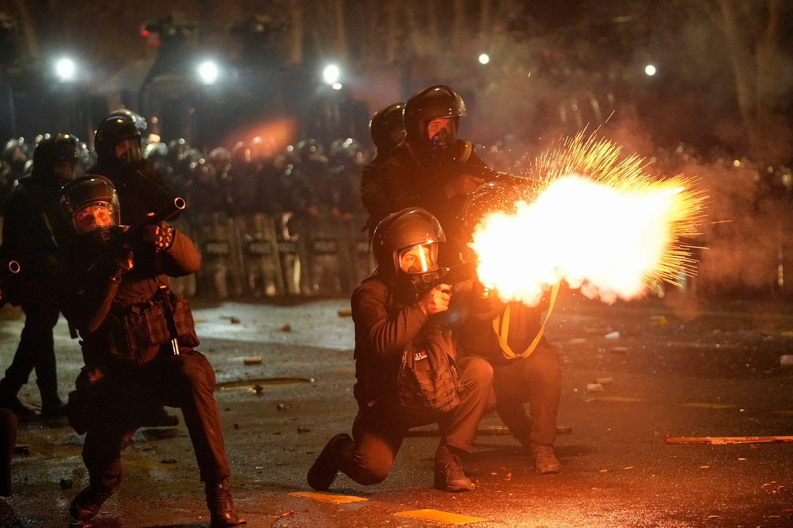 Police shoot tear gas towards demonstrators during a protest against the government's decision to suspend negotiations on joining the European Union in Tbilisi, Georgia, early Wednesday, Dec. 4, 2024. (AP Photo/Pavel Bednyakov)