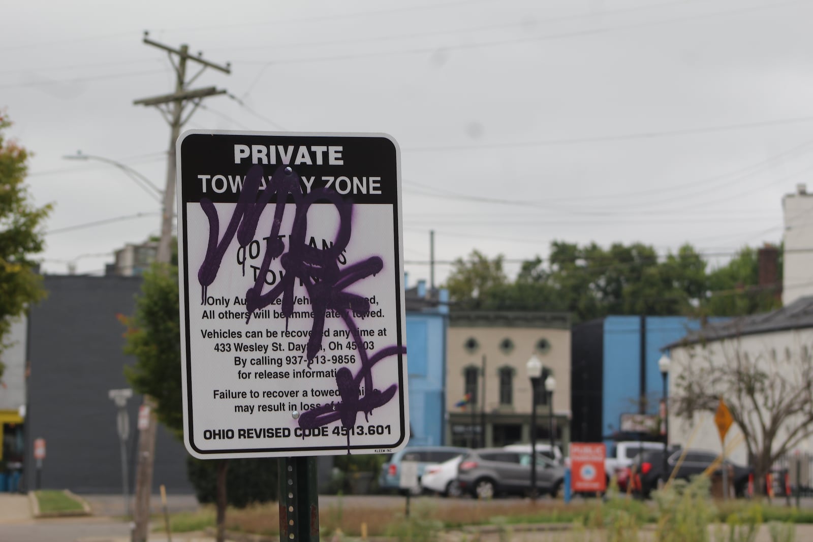 Graffiti on a sign in a parking lot in the Oregon District. CORNELIUS FROLIK / STAFF